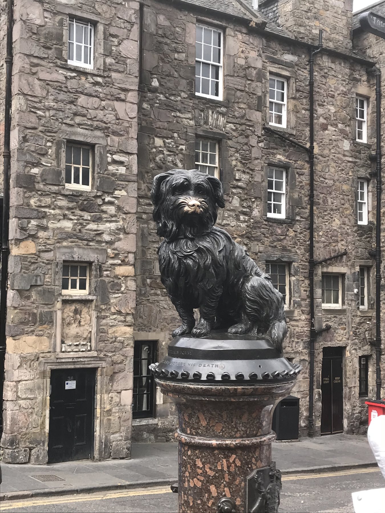 The bronze Greyfriars Bobby statue above its stone fountain in Edinburgh