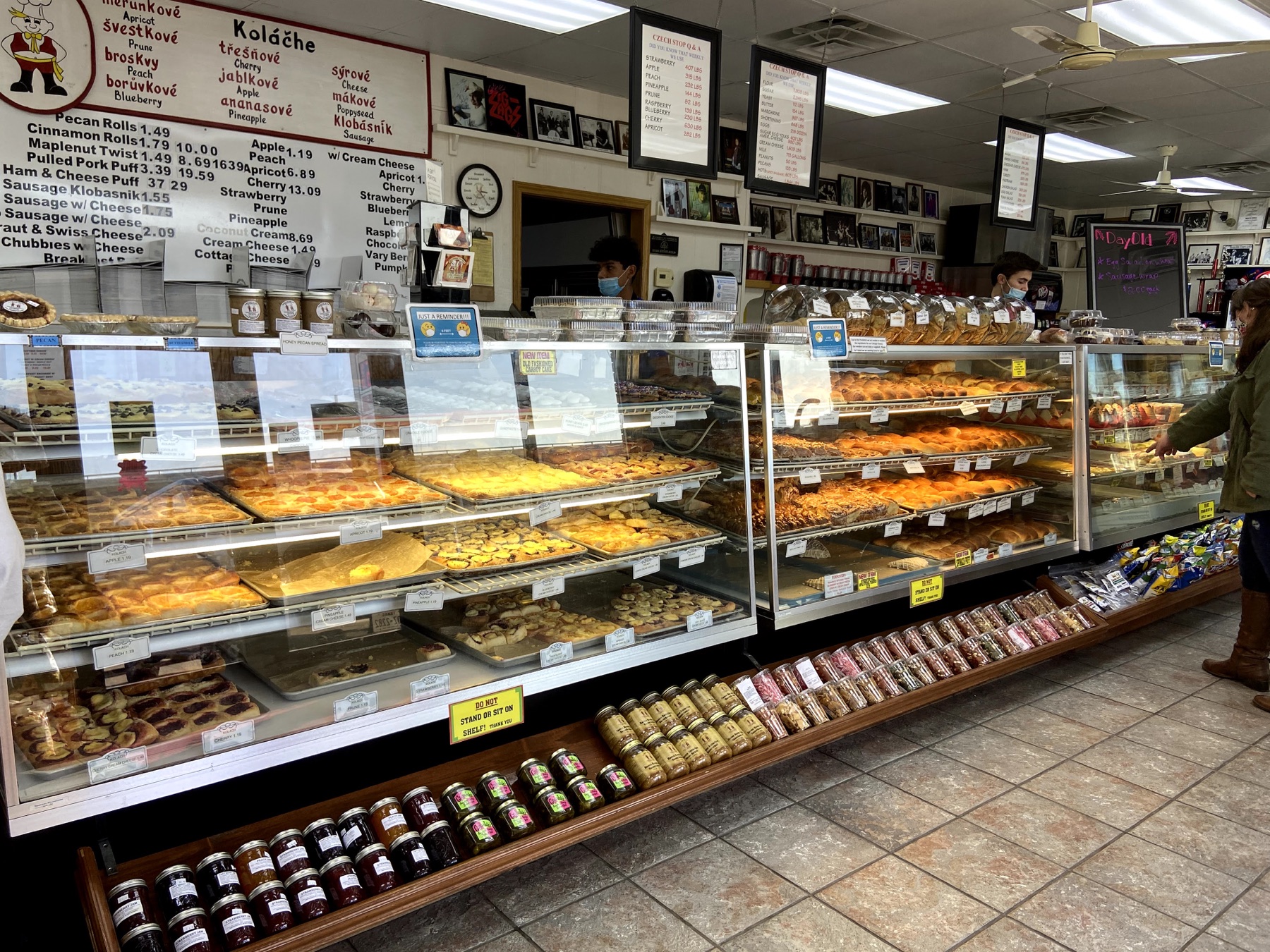 Display cases filled with fruit kolaches, pastries, and savory baked goods inside Czech Stop