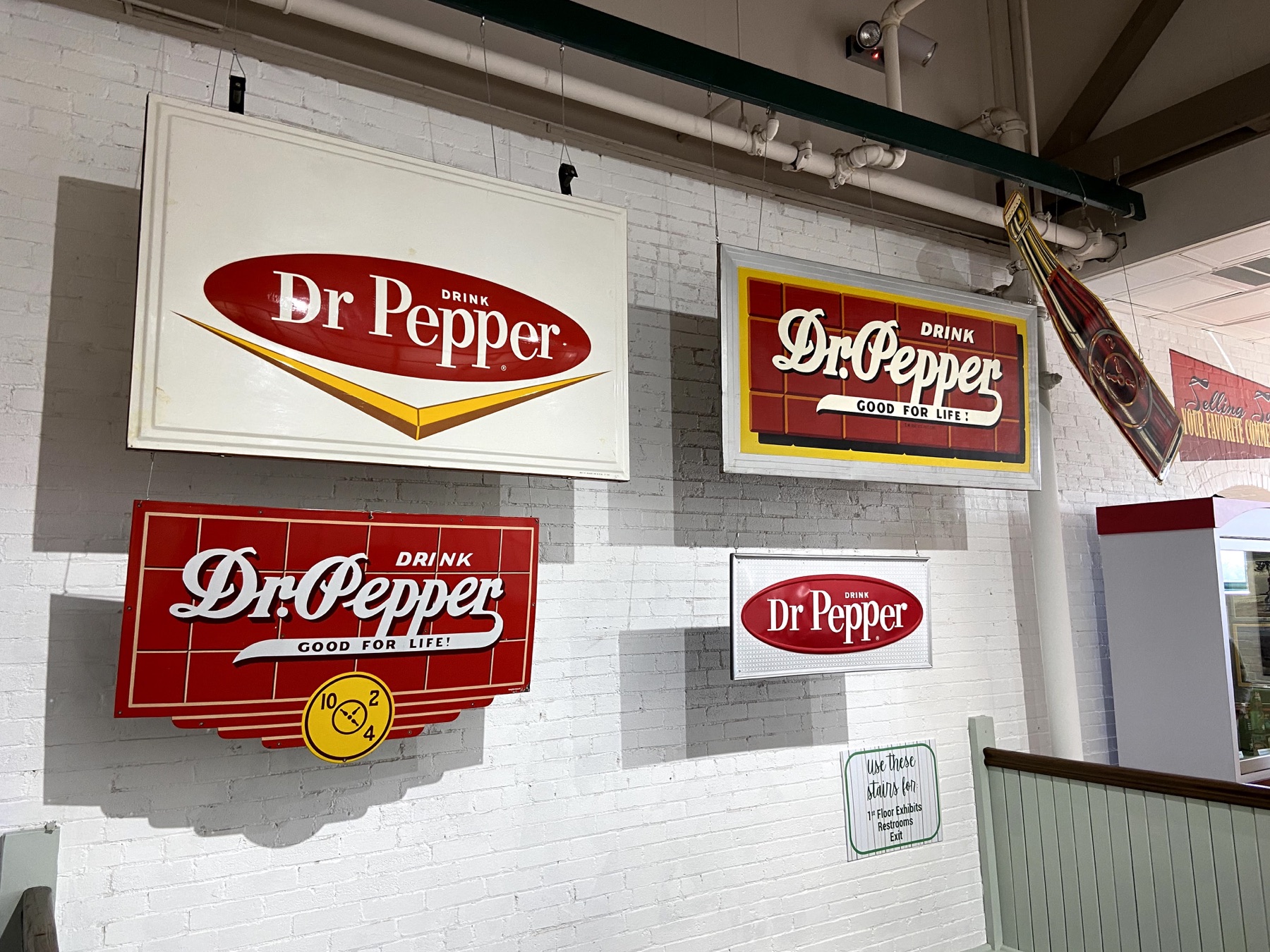 Vintage red and white Dr Pepper advertising signs displayed inside the museum
