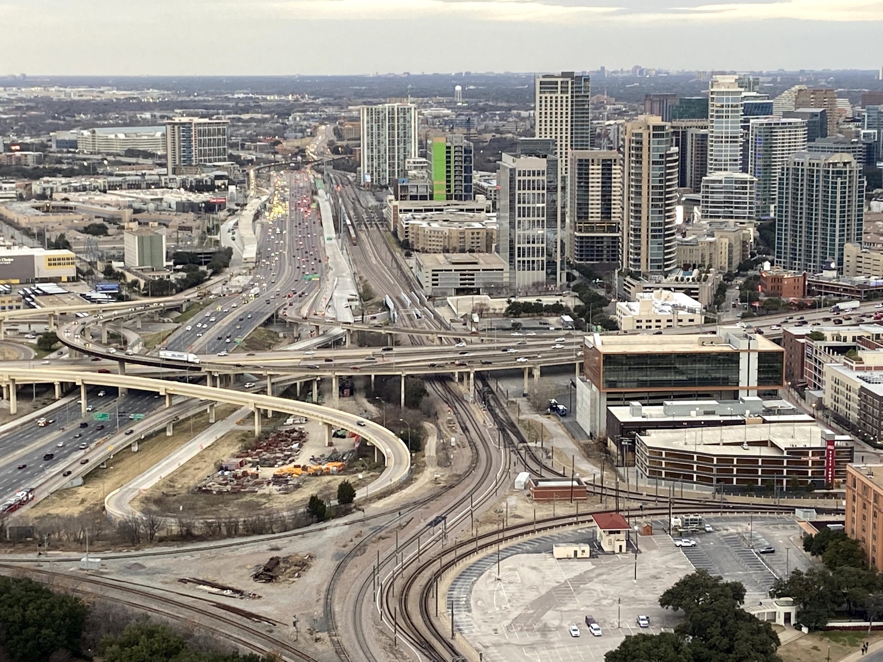 Dallas highways, rail lines, and city buildings viewed from Reunion Tower near dusk