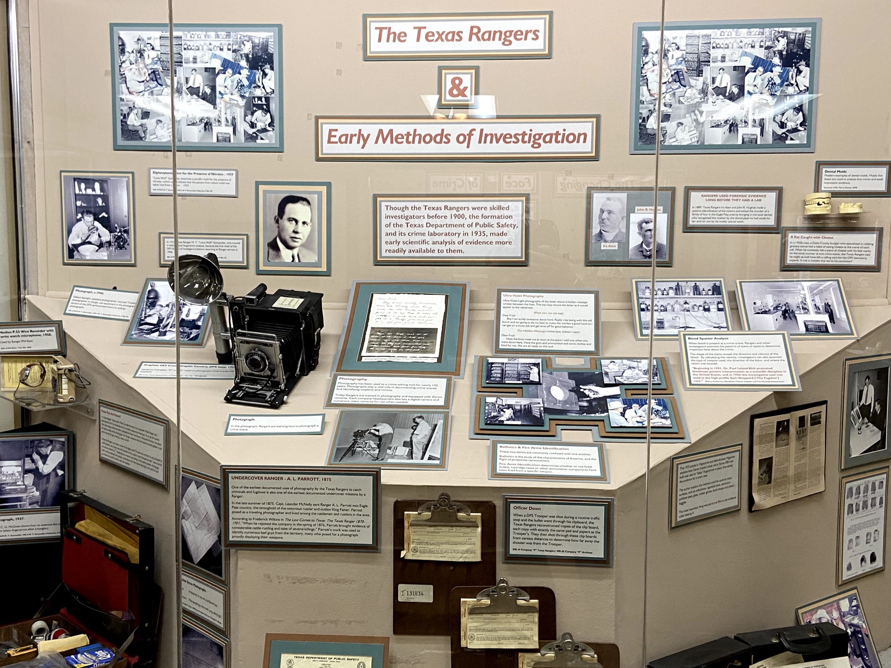 Texas Ranger museum exhibit about early investigative methods with cameras, documents, and photographs