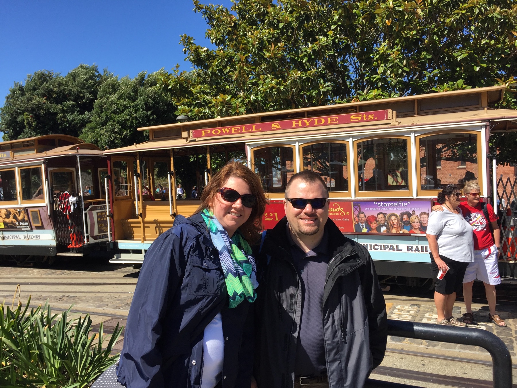 Angela and Brian standing in front of a Powell and Hyde cable car in San Francisco