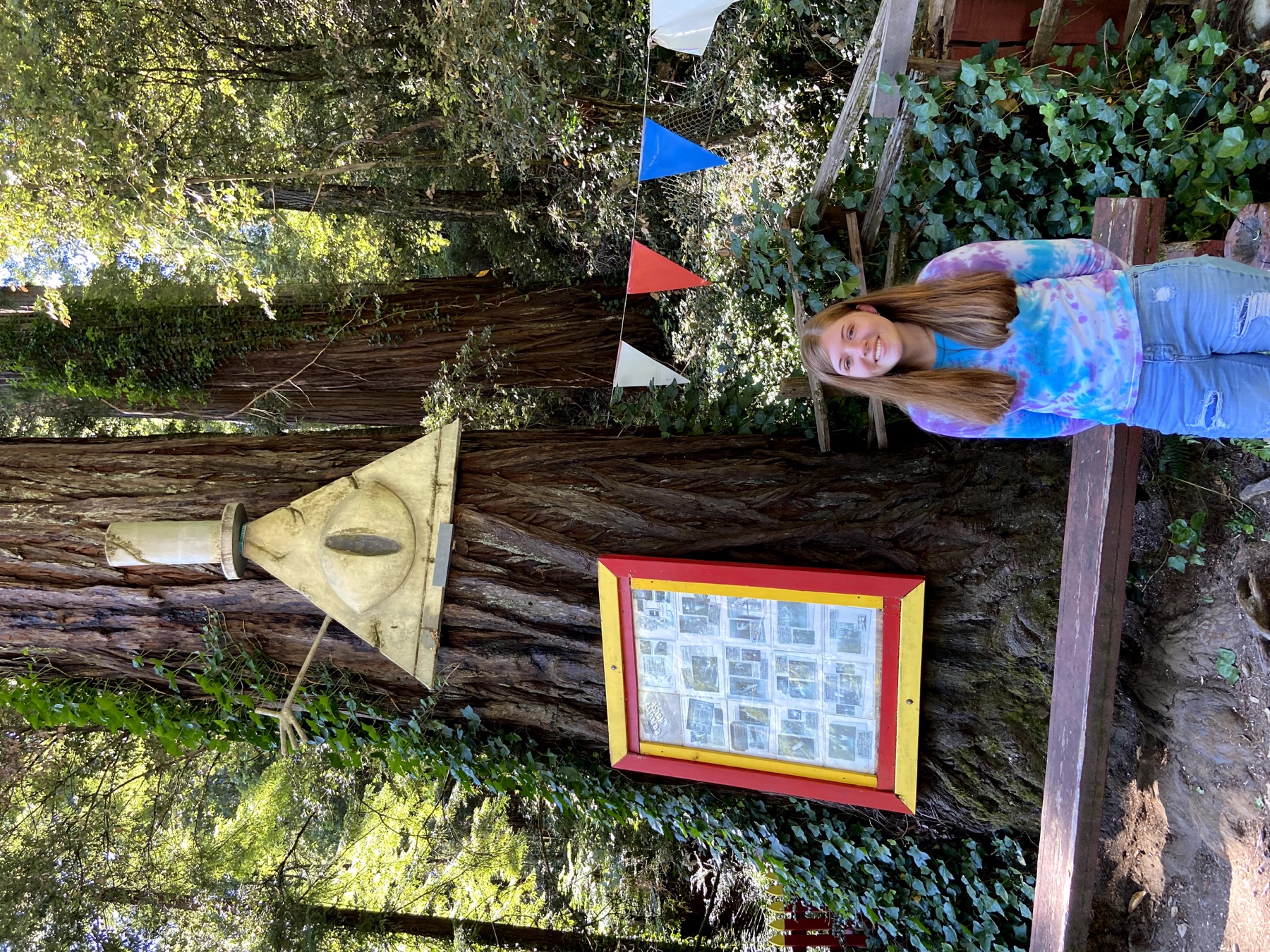 Madison standing beside the Mystery Shack-inspired attraction at Confusion Hill