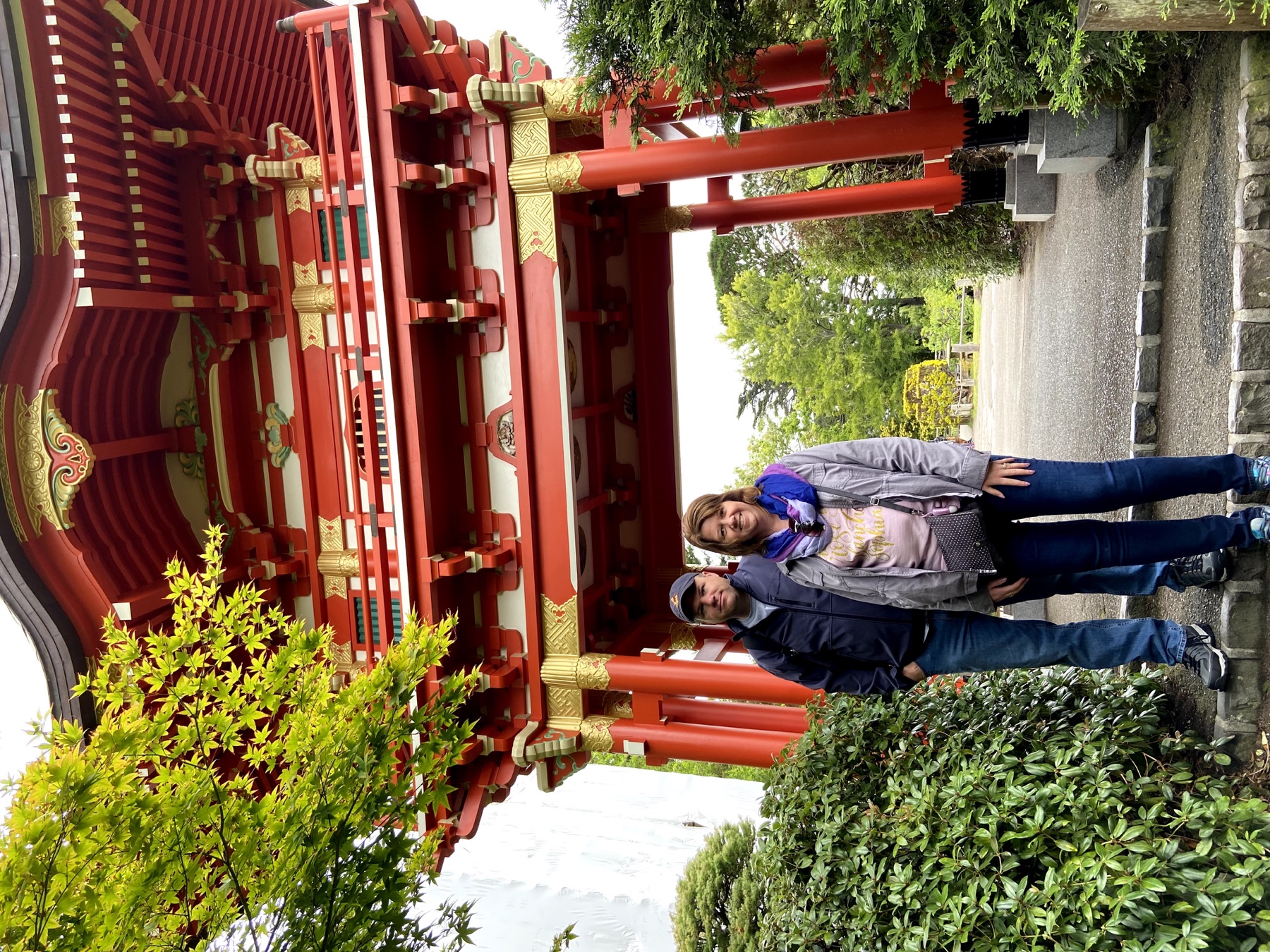 Angela and Brian standing beneath a red gate at the Japanese Tea Garden in Golden Gate Park