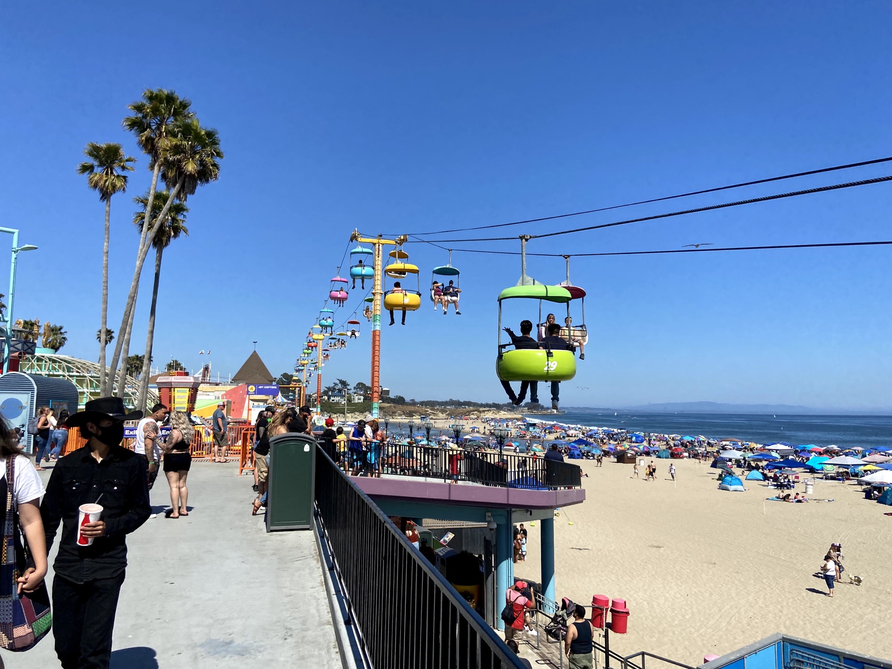 Sky ride over the crowded Santa Cruz Beach Boardwalk and sandy beach
