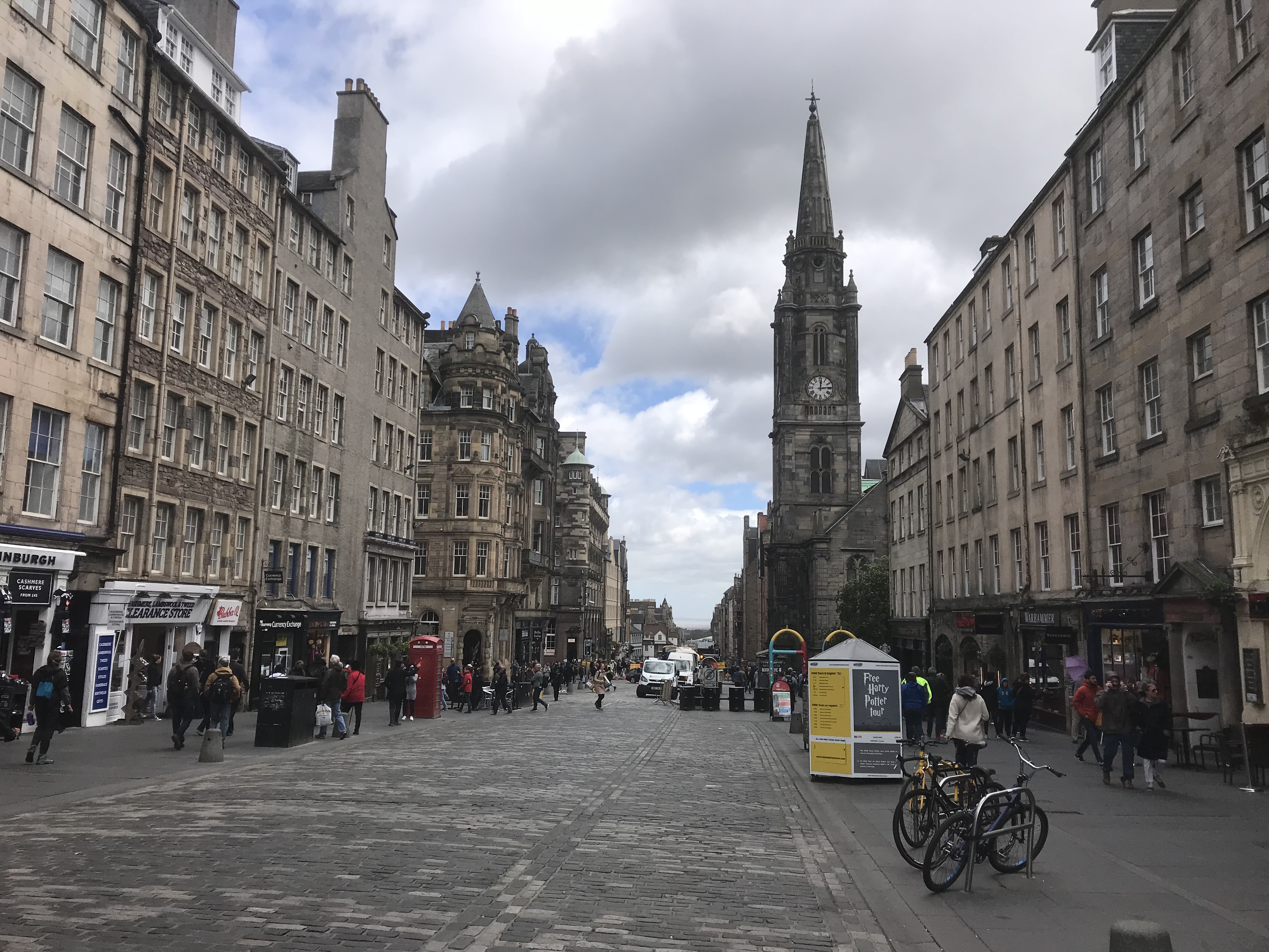 Historic stone buildings and a busy street in Edinburgh