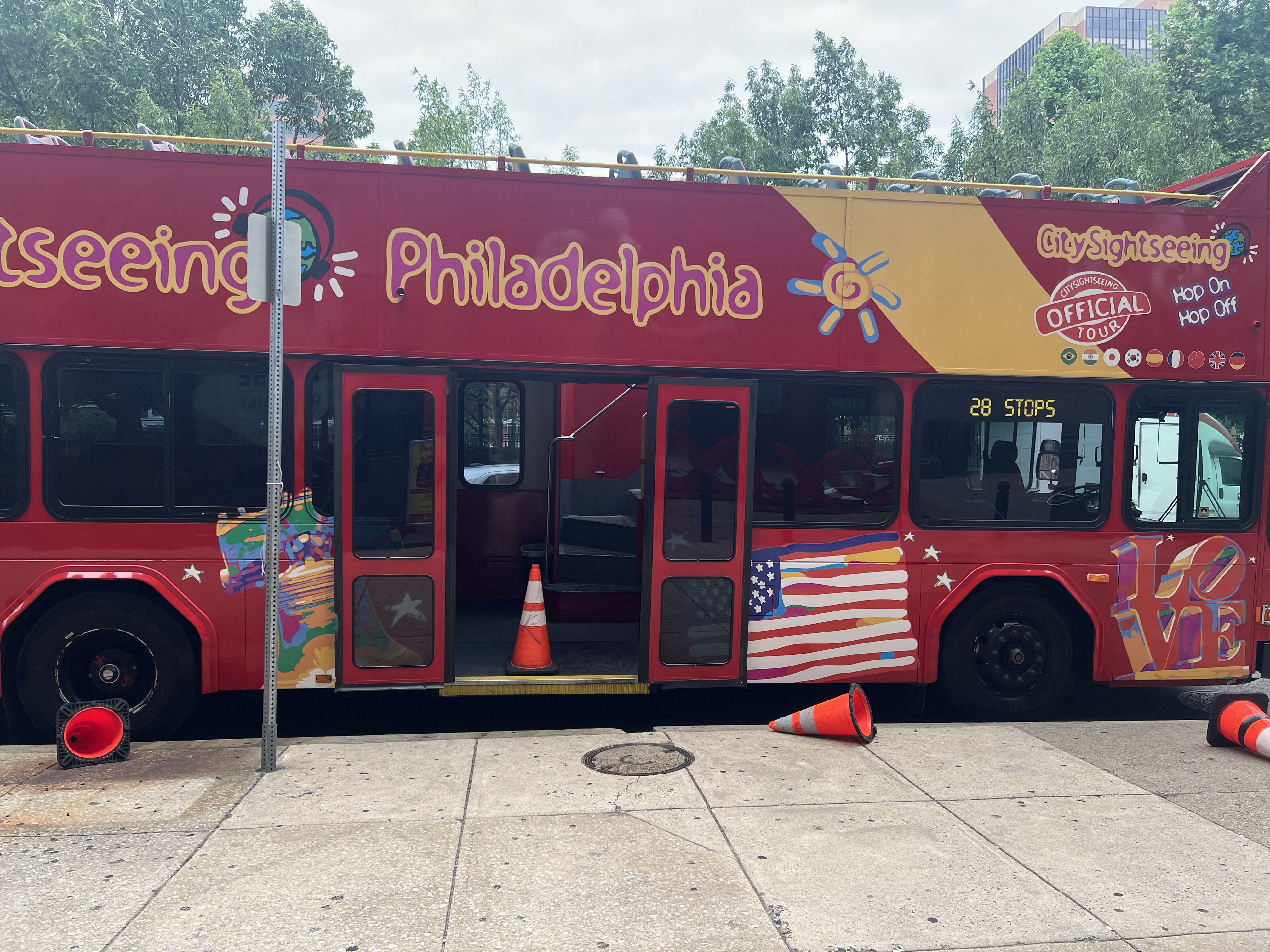 Bright red double-decker sightseeing bus parked on a Philadelphia street