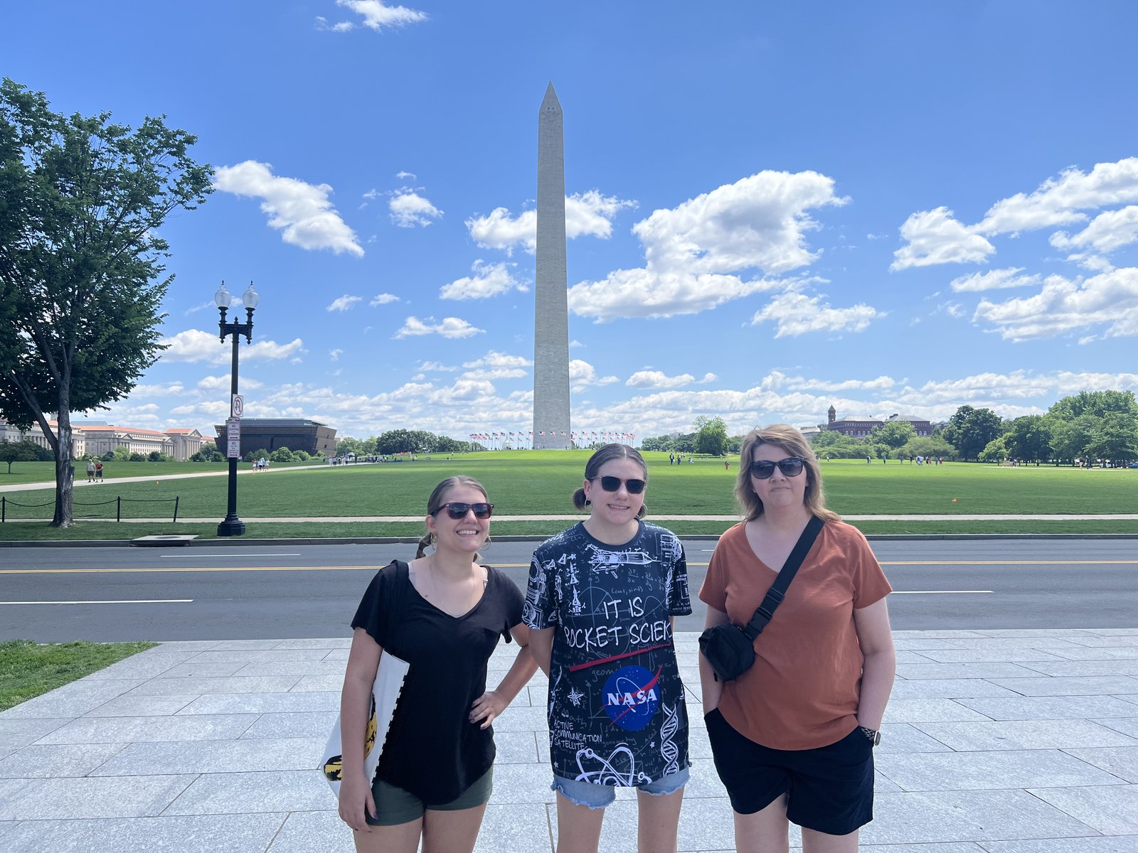Angela and two of her daughters standing on the National Mall with the Washington Monument behind them