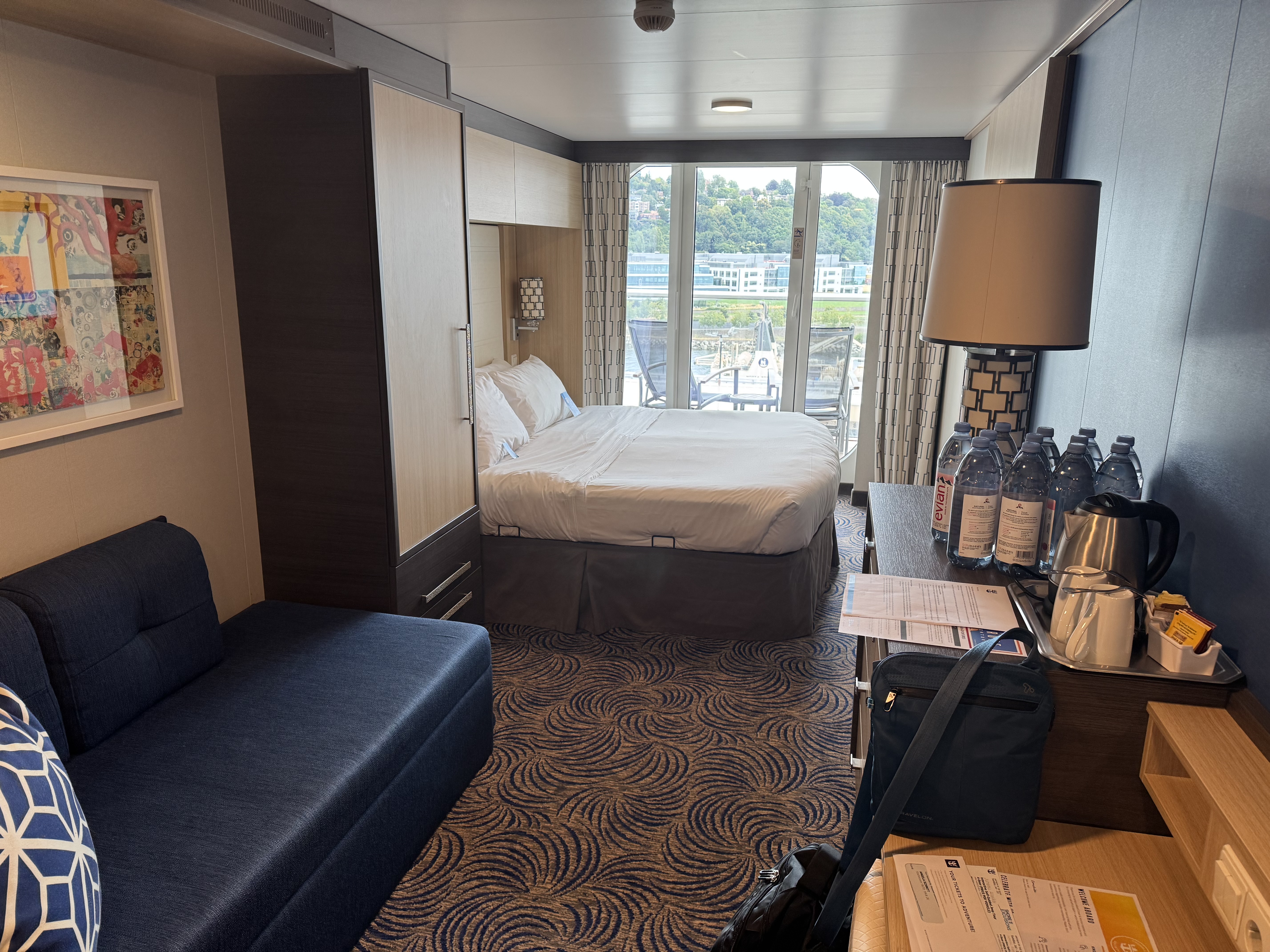A balcony stateroom aboard Anthem of the Seas with a view toward the ship’s outdoor balcony