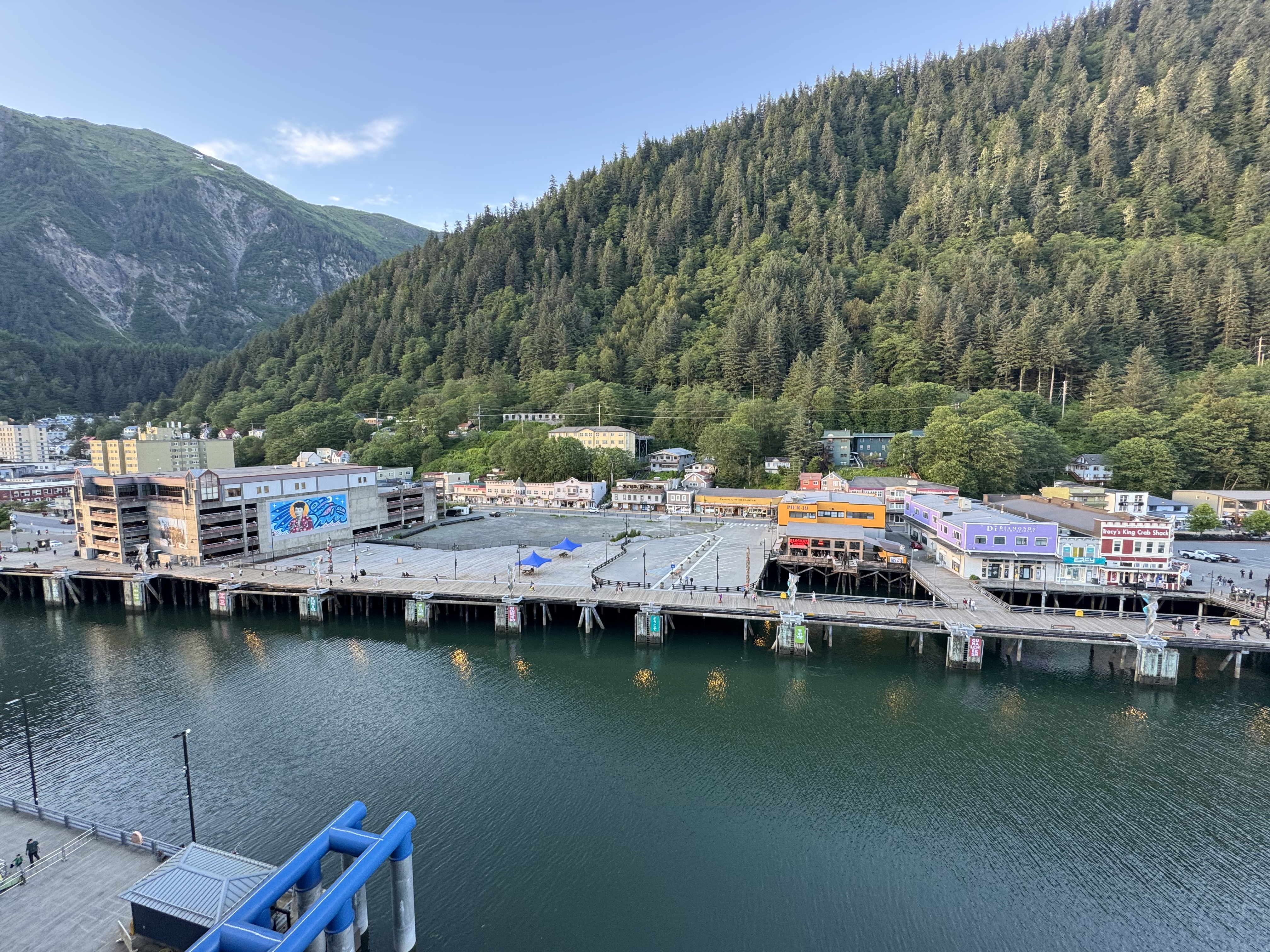 Juneau’s waterfront and colorful downtown buildings beneath a forested mountainside