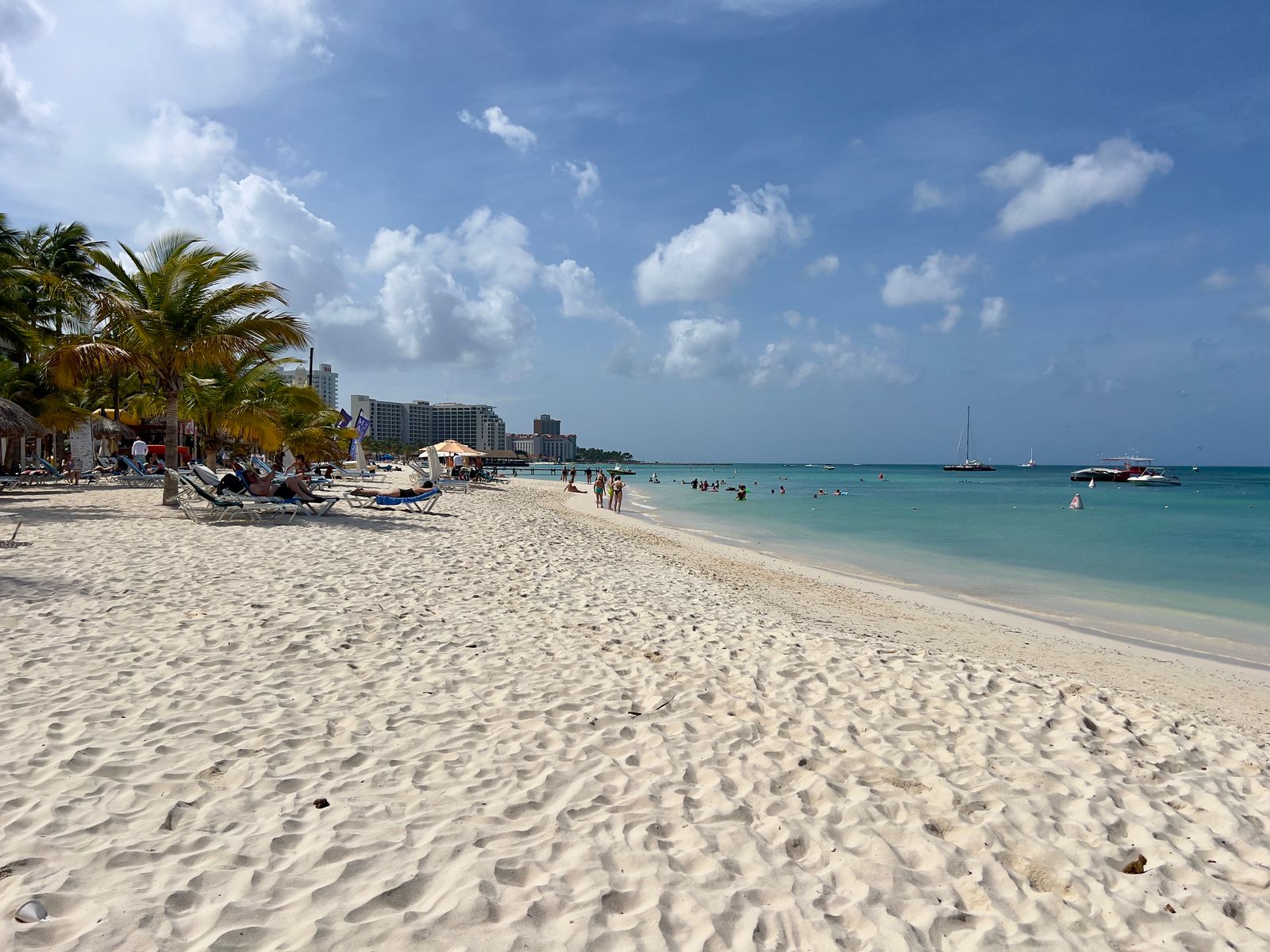 White sand, palm trees, and calm turquoise water at Palm Beach in Aruba