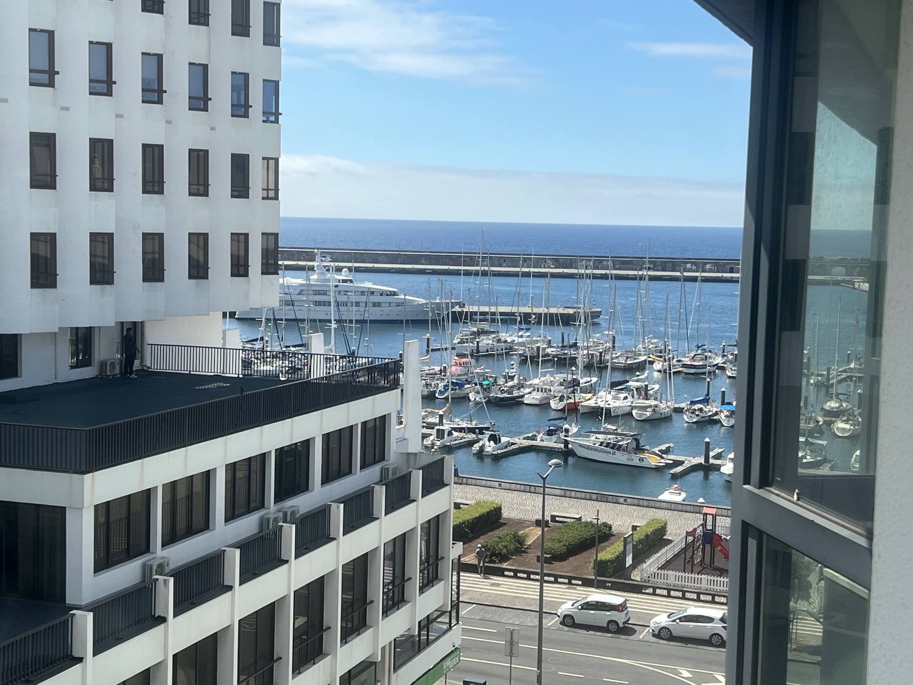 Ponta Delgada marina and blue ocean viewed from a hotel balcony