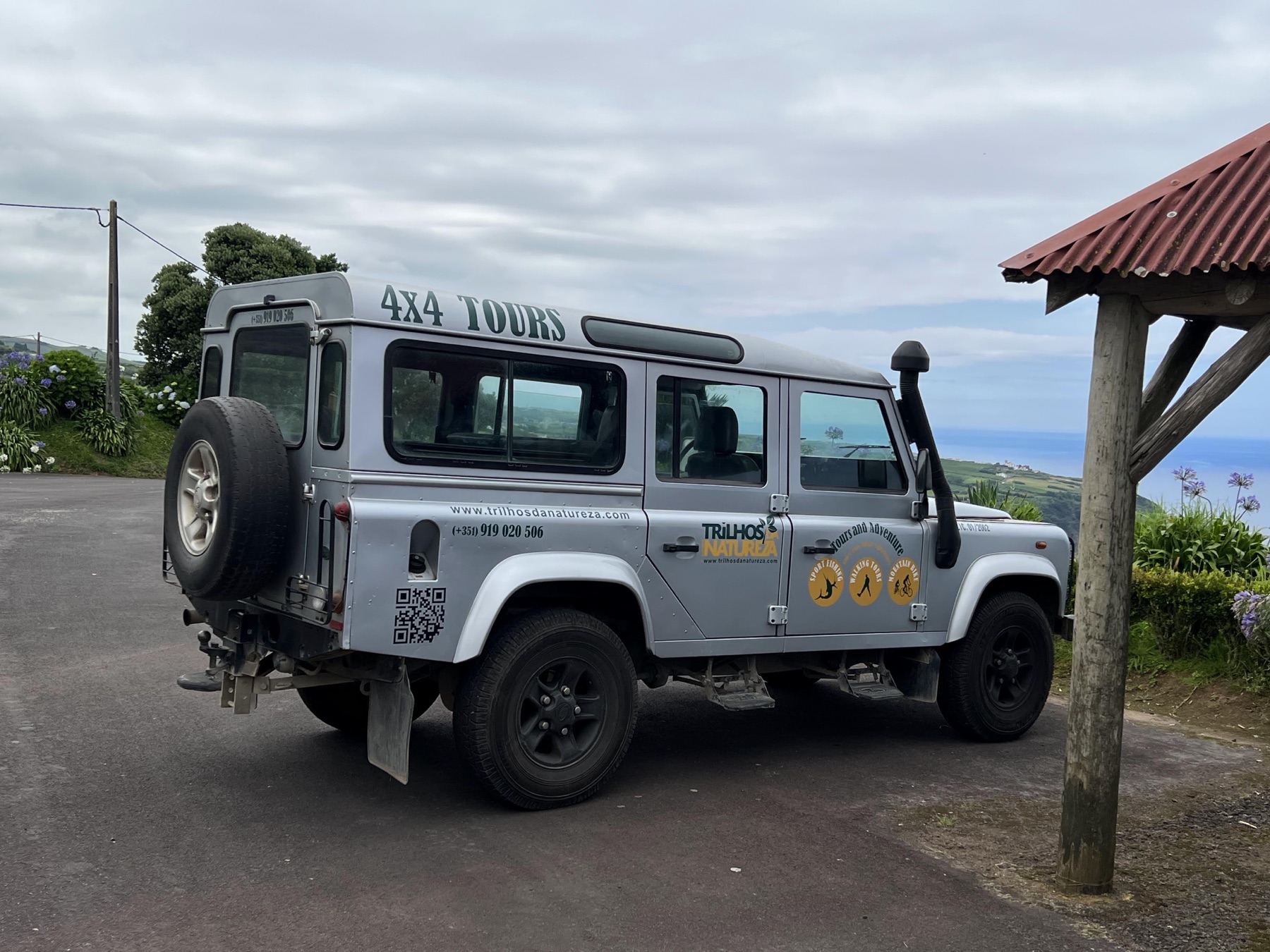 Gray four-wheel-drive Jeep parked at a scenic São Miguel overlook