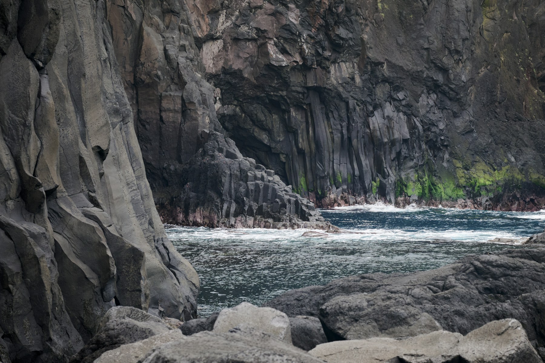 Atlantic waves meeting a rugged black volcanic coastline in the Azores