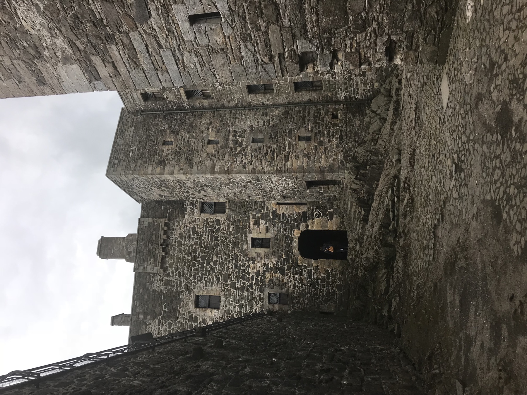 Narrow stone courtyard enclosed by the towers of Blackness Castle