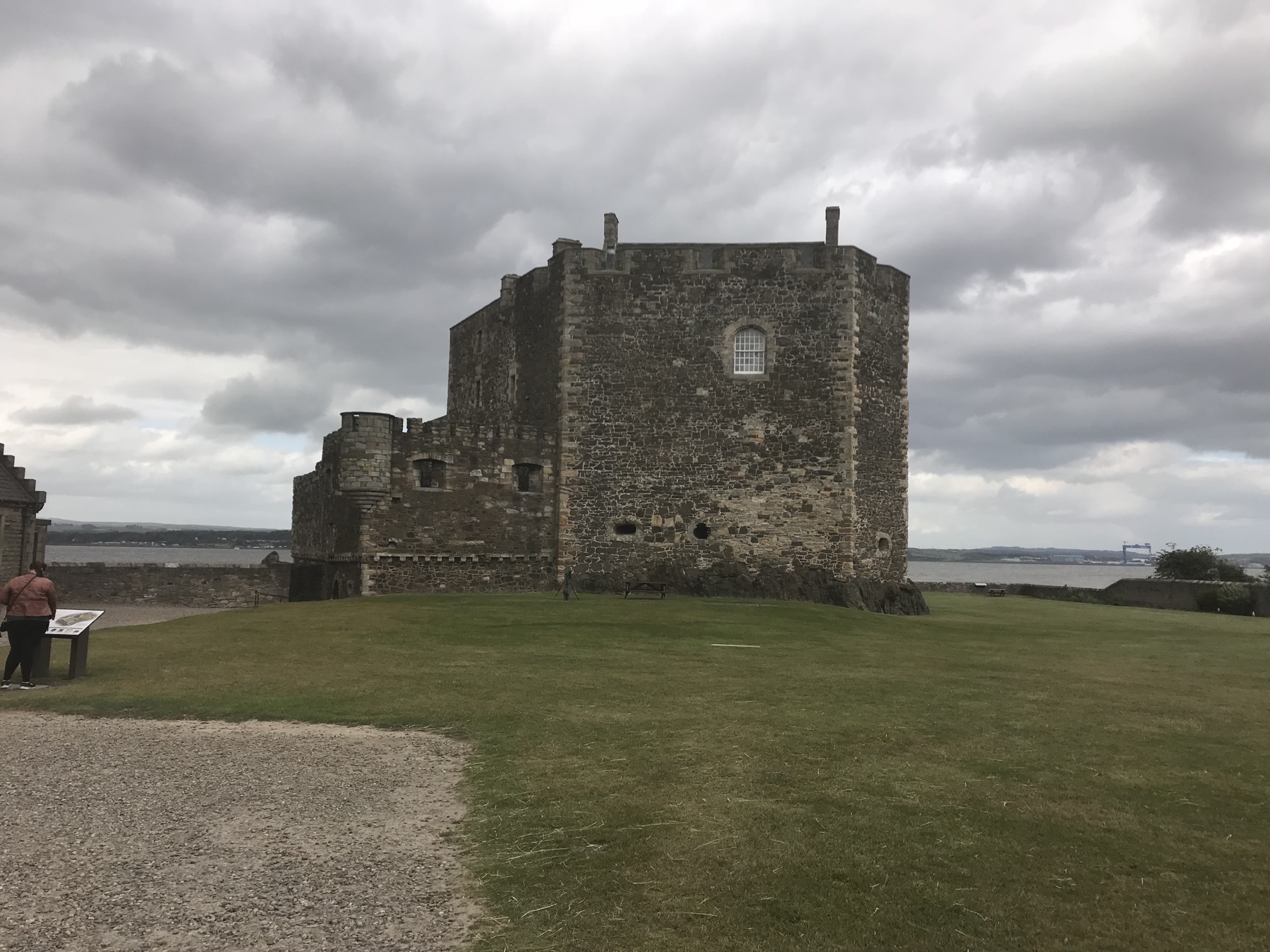 Blackness Castle rising above a lawn beside the Firth of Forth