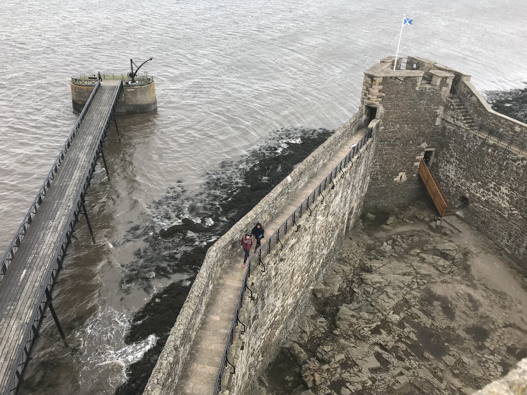 Defensive wall and wooden pier at Blackness Castle viewed from above