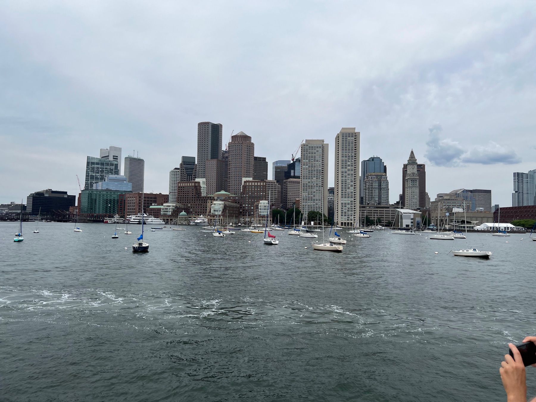 Boston skyline and sailboats viewed across Boston Harbor