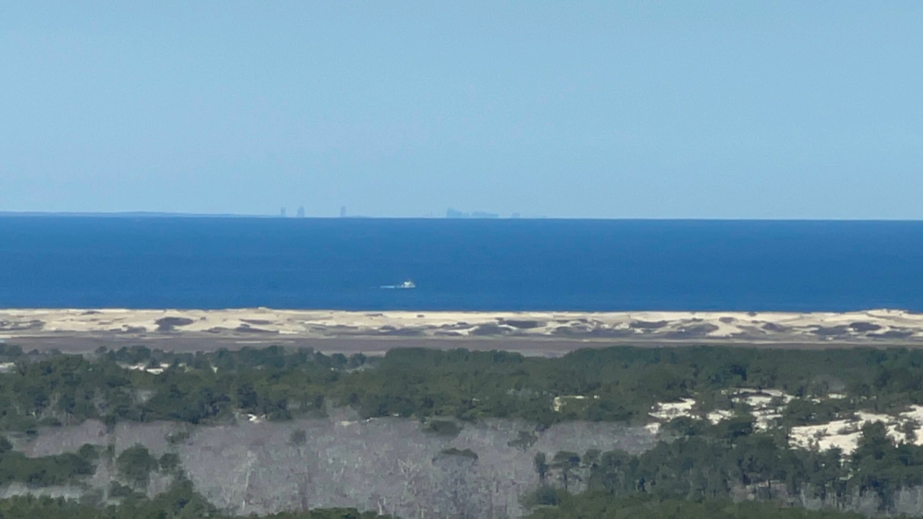Distant Boston skyline across the water beyond the dunes near Provincetown