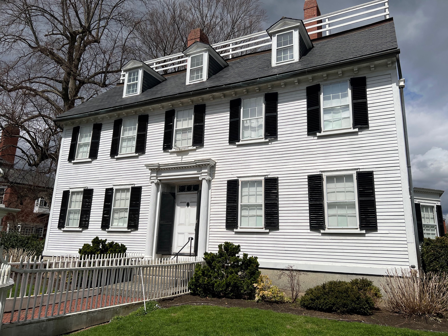 White clapboard historic house with black shutters in Salem