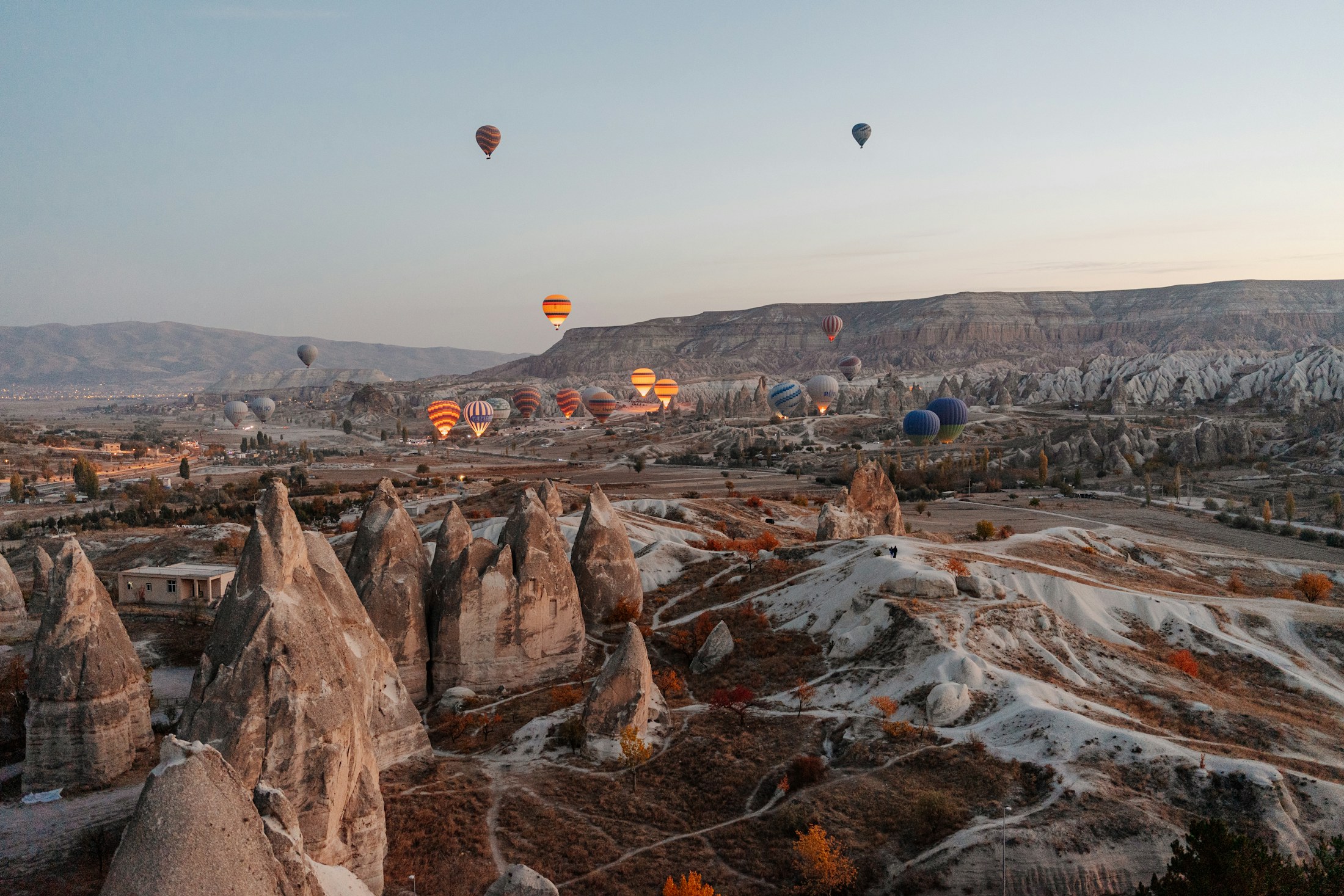 Hot-air balloons floating over Cappadocia at sunrise