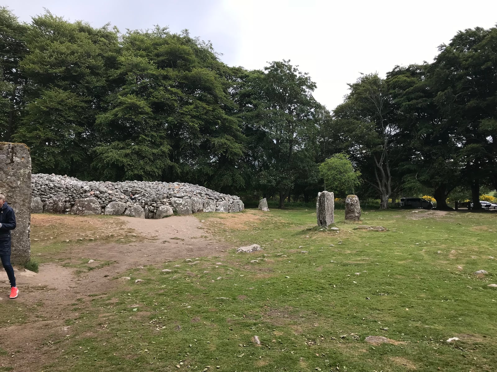 Standing stones positioned beside a broad circular cairn at Clava Cairns