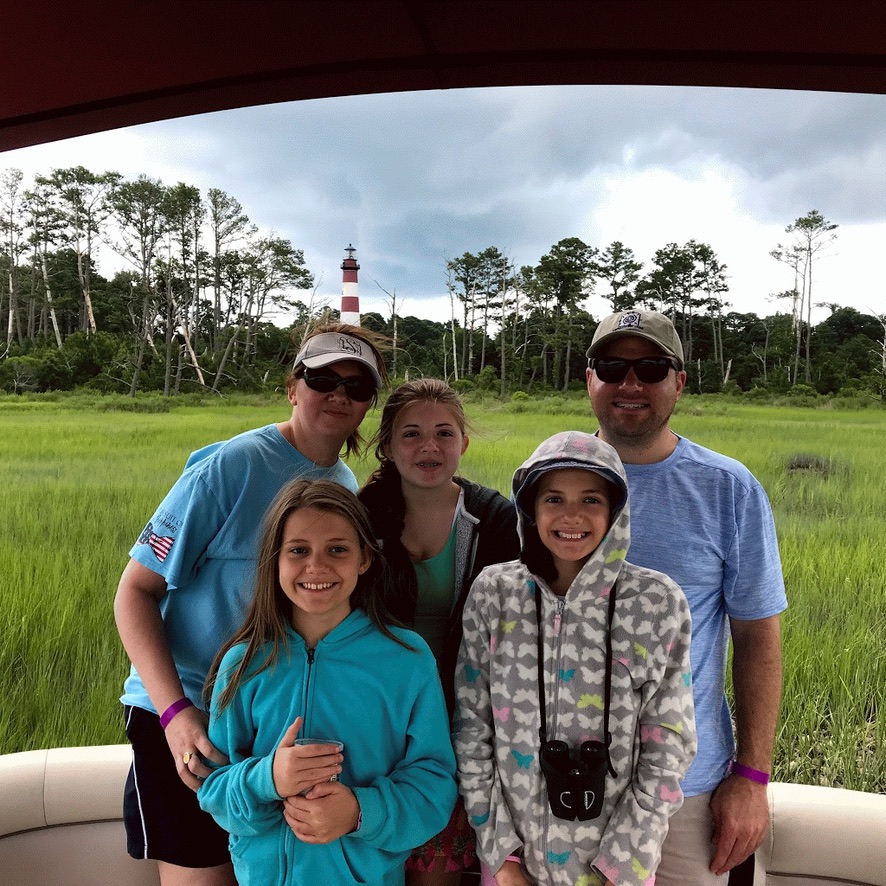 Angie and her family visiting the Assateague Lighthouse near Chincoteague Island