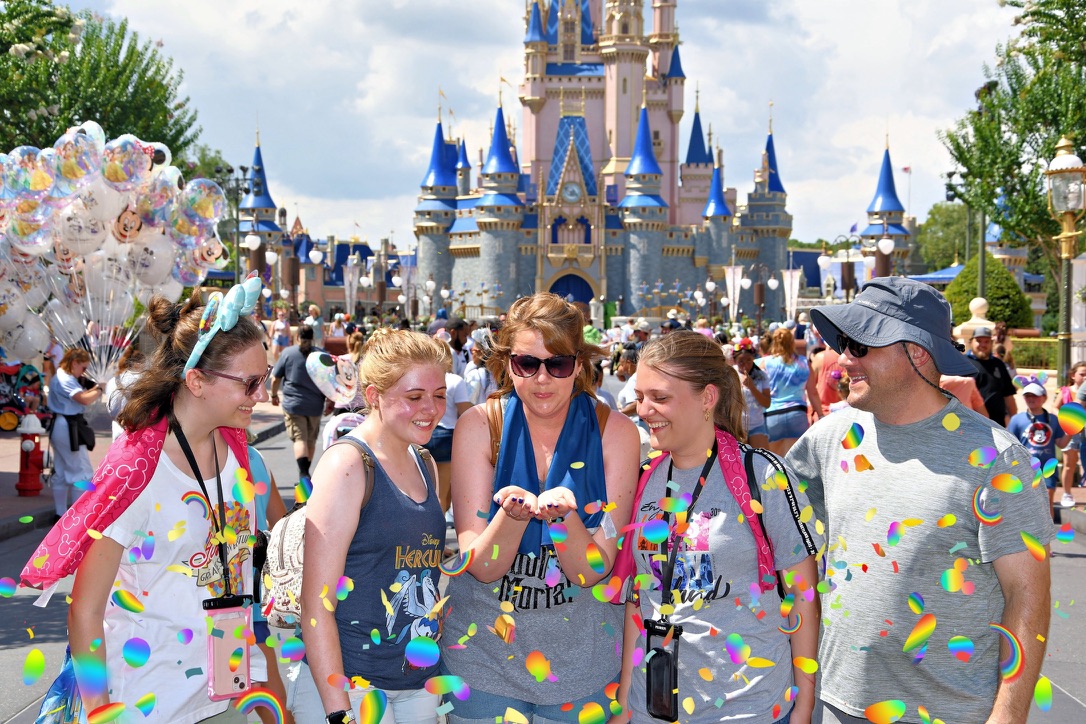 Angie’s family with their grown daughters in front of Cinderella Castle at Walt Disney World