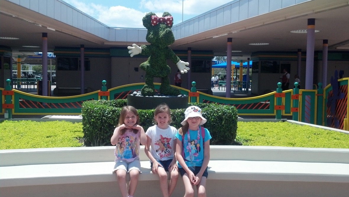 Angie’s three young daughters sitting together at Walt Disney World