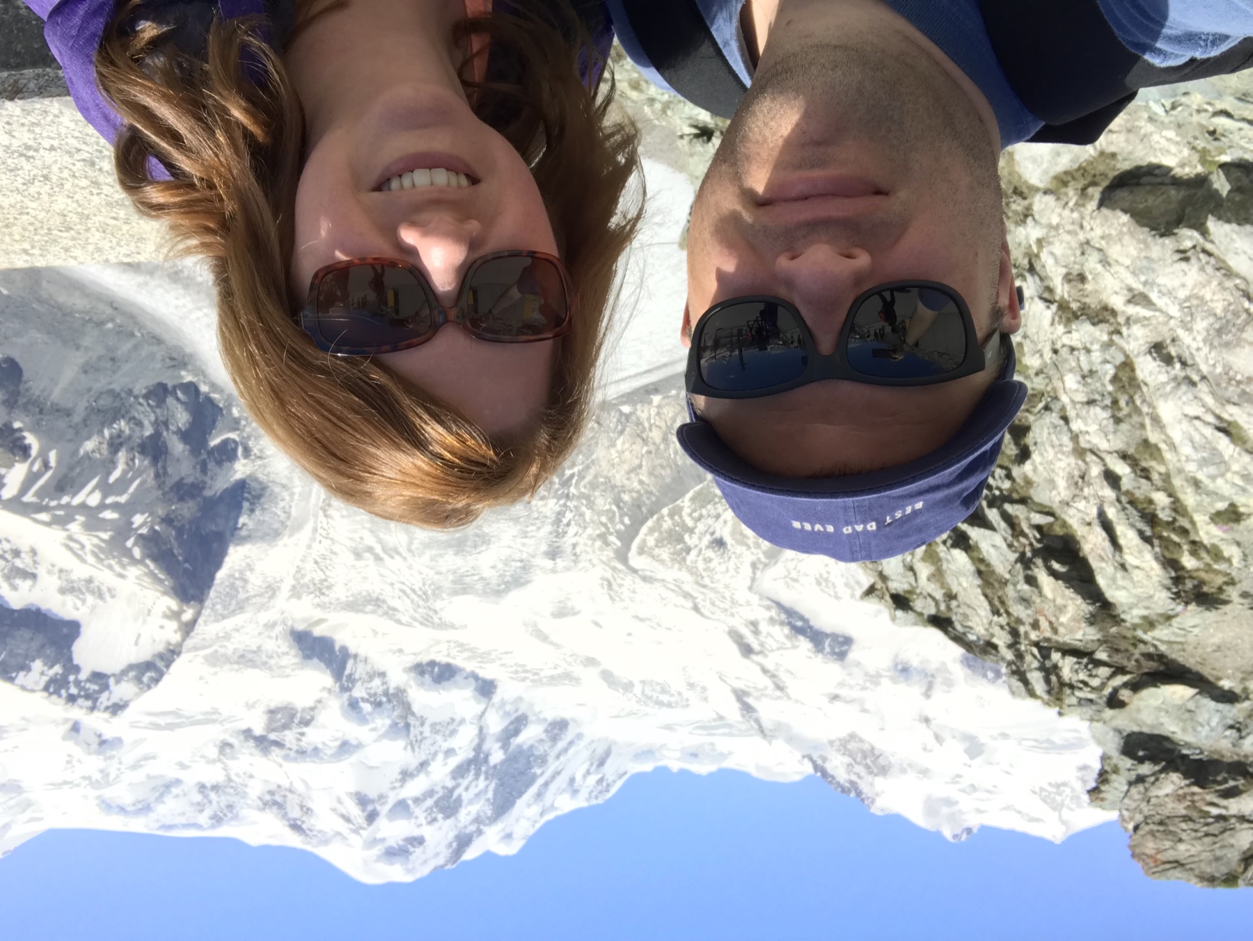 Angela and Brian smiling in front of snowy peaks and glaciers along the Gornergrat route
