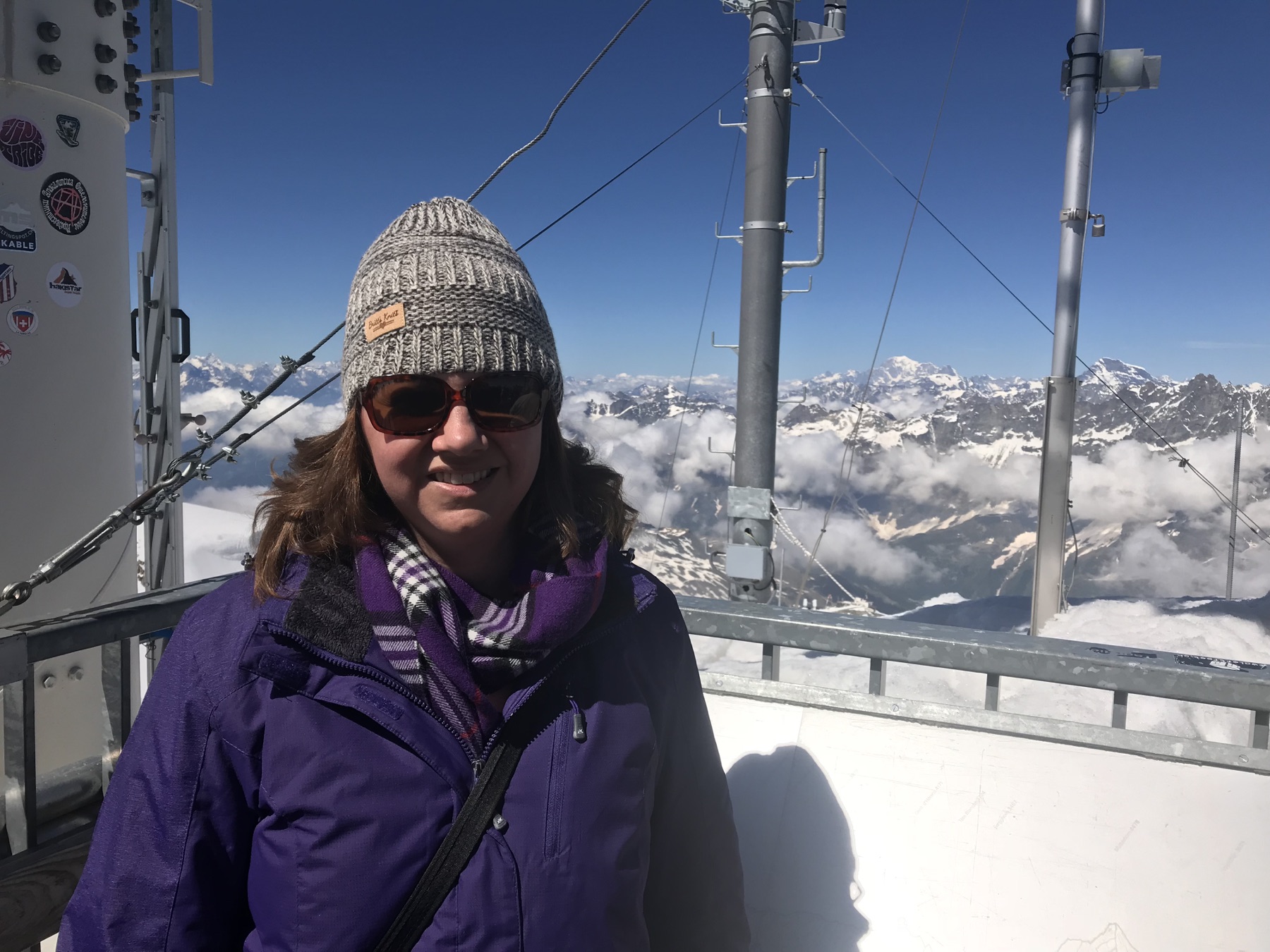 Angela bundled in winter clothing above the clouds at Matterhorn Glacier Paradise in June