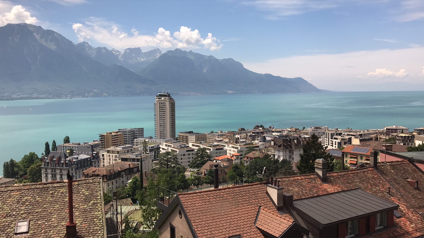 Montreux rooftops and Lake Geneva viewed from the train climbing above town