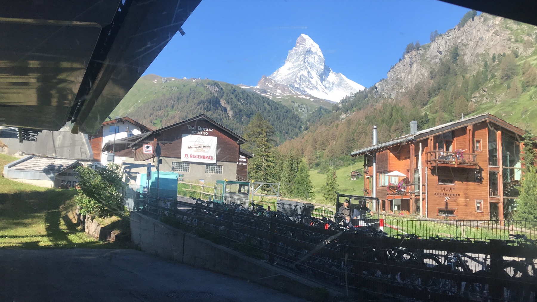 The Matterhorn rising above chalet-style buildings near the railway in Zermatt