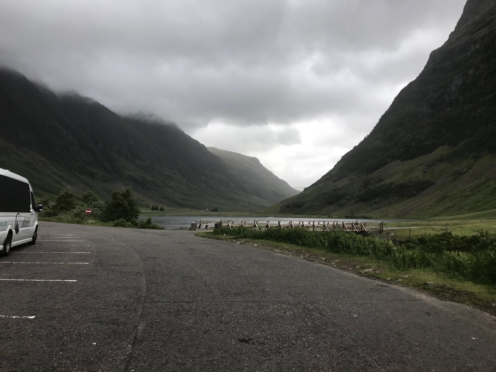 Roadside parking area surrounded by the steep mountains of Glencoe