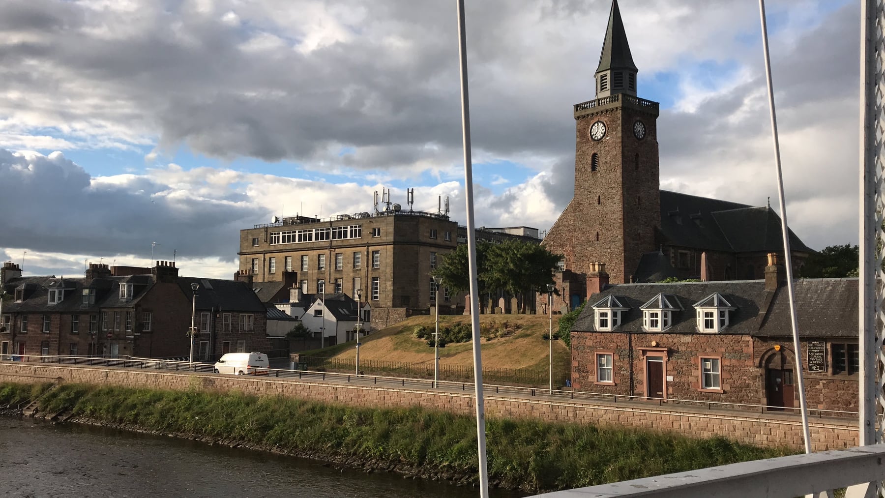 Stone church with a clock tower beside the River Ness in Inverness