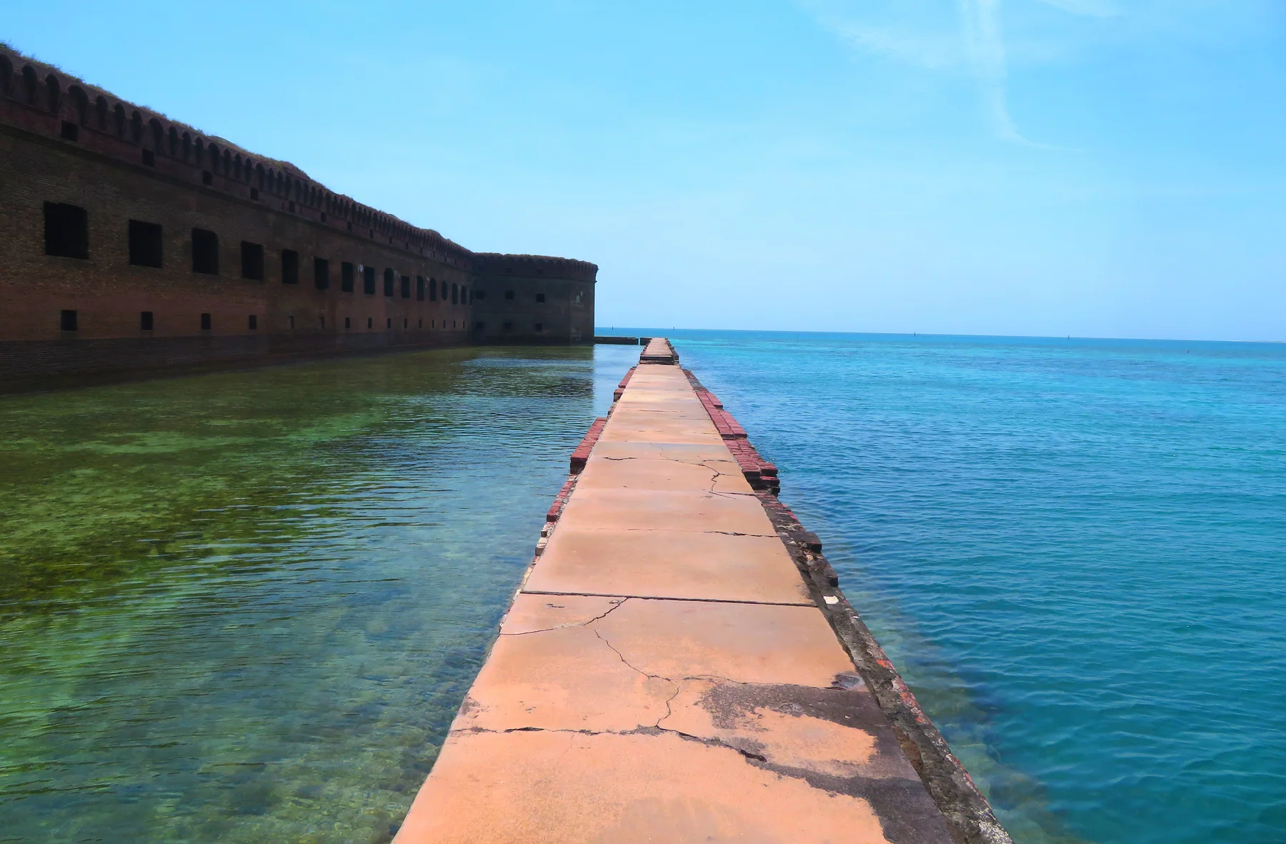Fort Jefferson’s brick moat wall leading into clear turquoise water at Dry Tortugas National Park