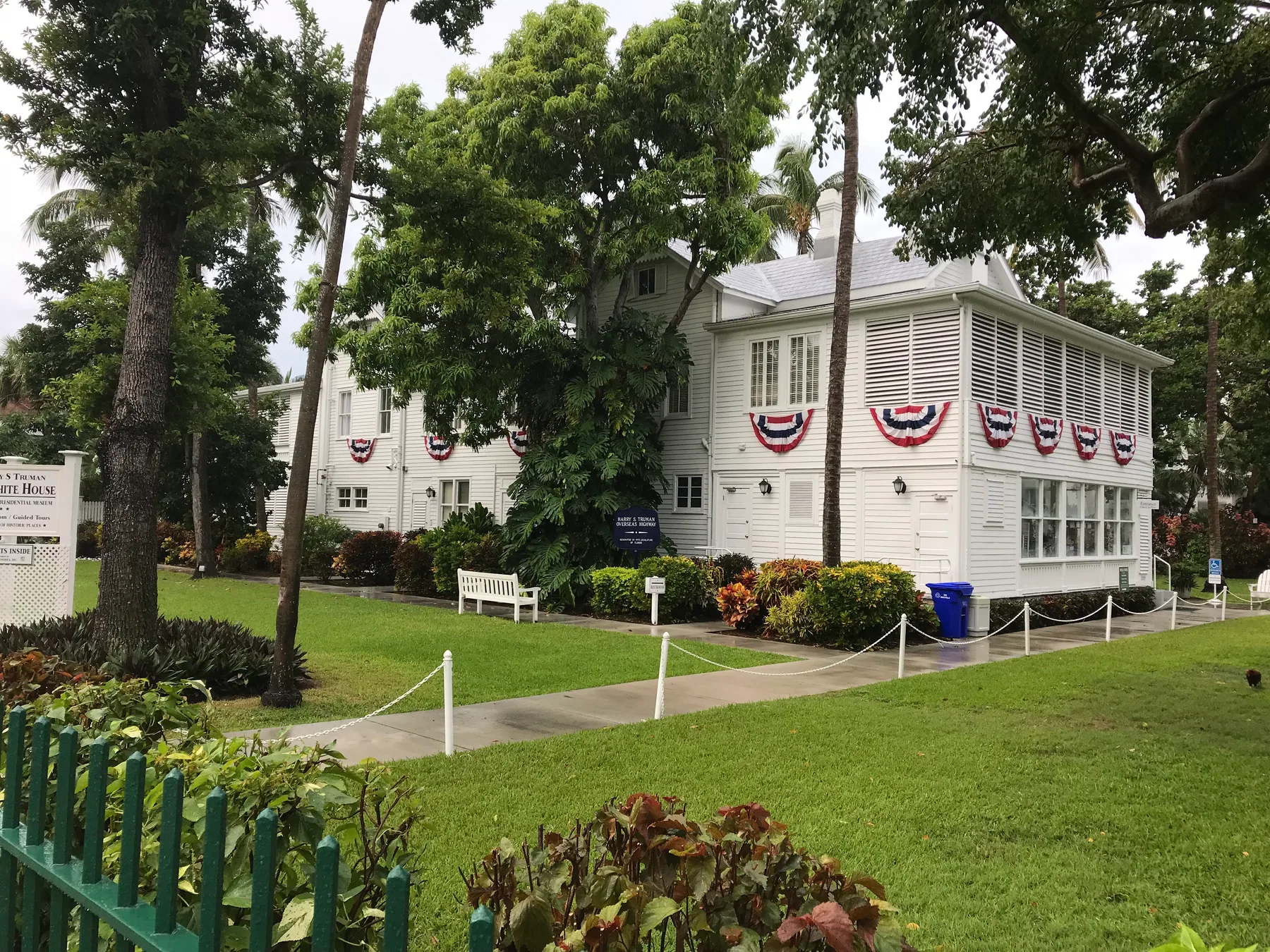 Harry S. Truman Little White House surrounded by palms, shade trees, and a green lawn