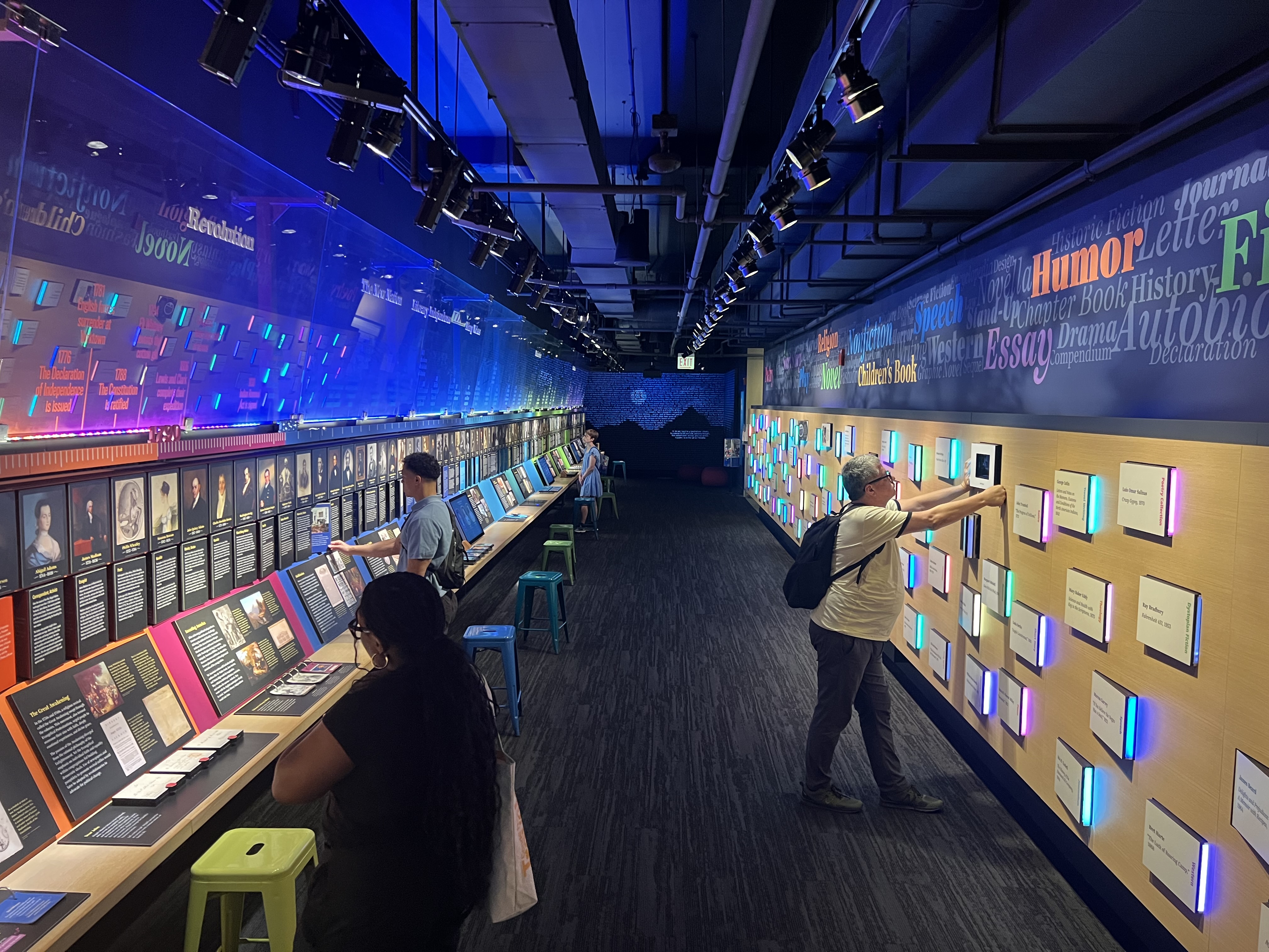 Visitors exploring colorful interactive displays in the American Writers Museum's American writing gallery