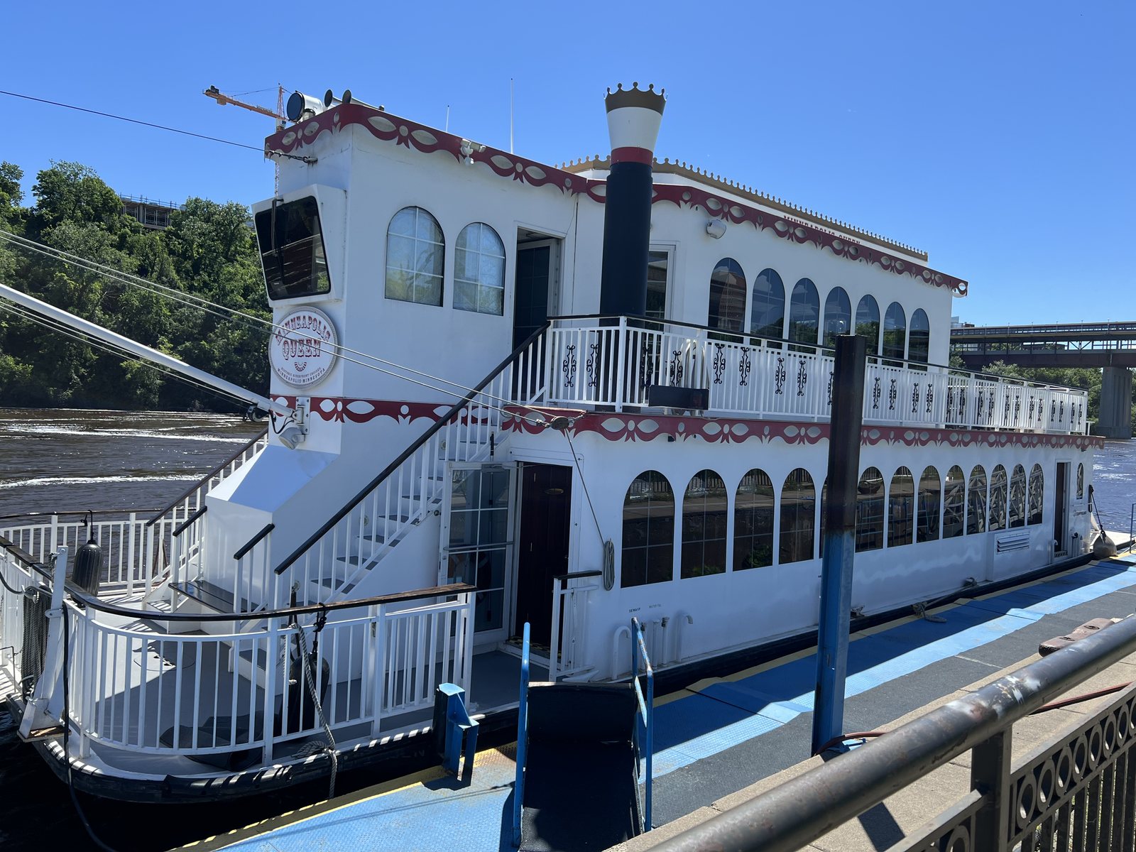 The white and red Minneapolis Queen riverboat docked at Bohemian Flats