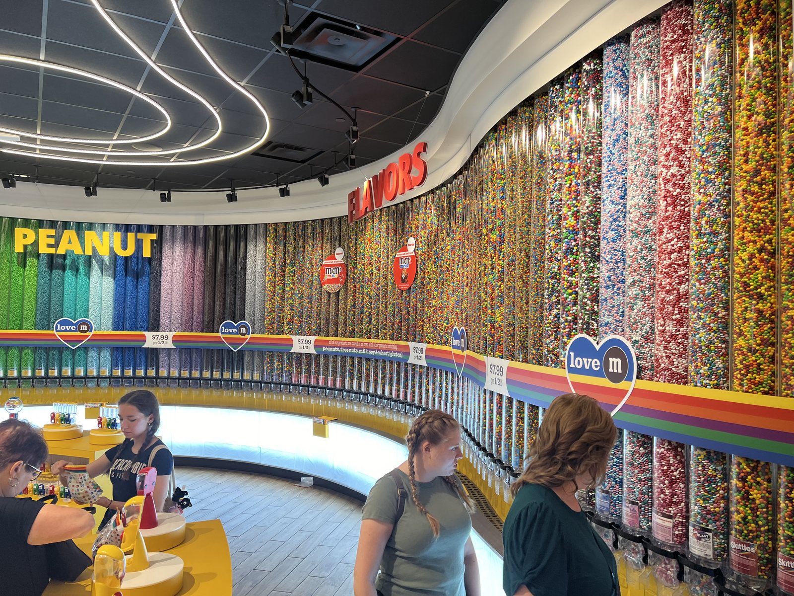 Tall transparent dispensers filled with many colors of M and M candies inside the M and M's store
