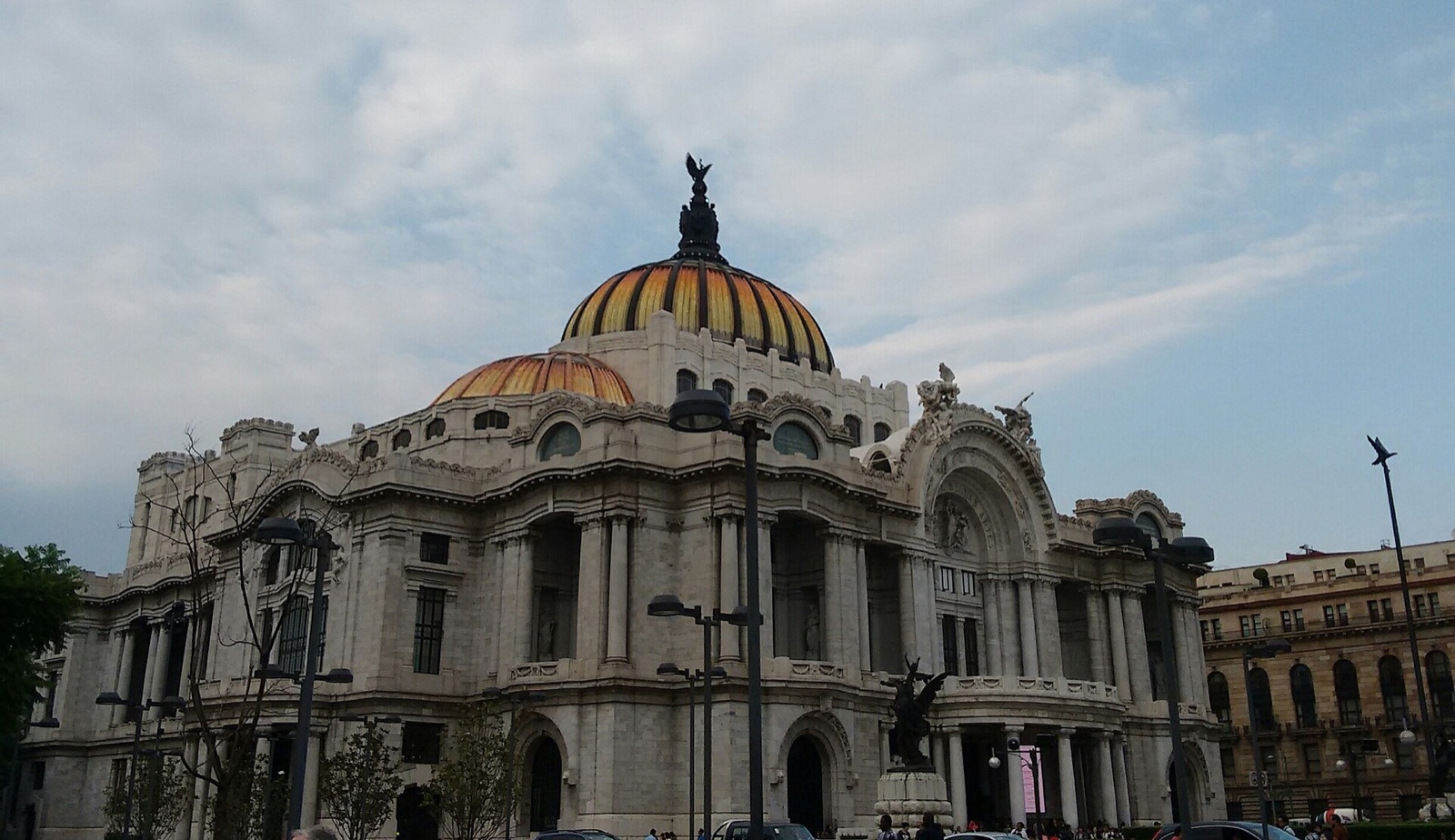 White marble Palacio de Bellas Artes with its orange-and-yellow dome in Mexico City