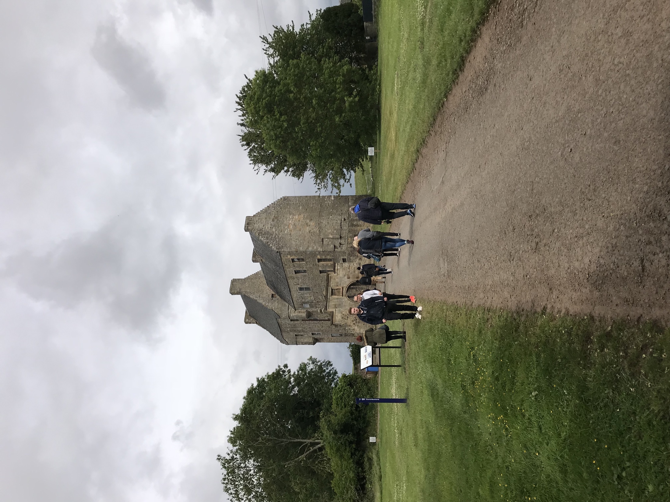 Visitors walking toward Midhope Castle along the estate path