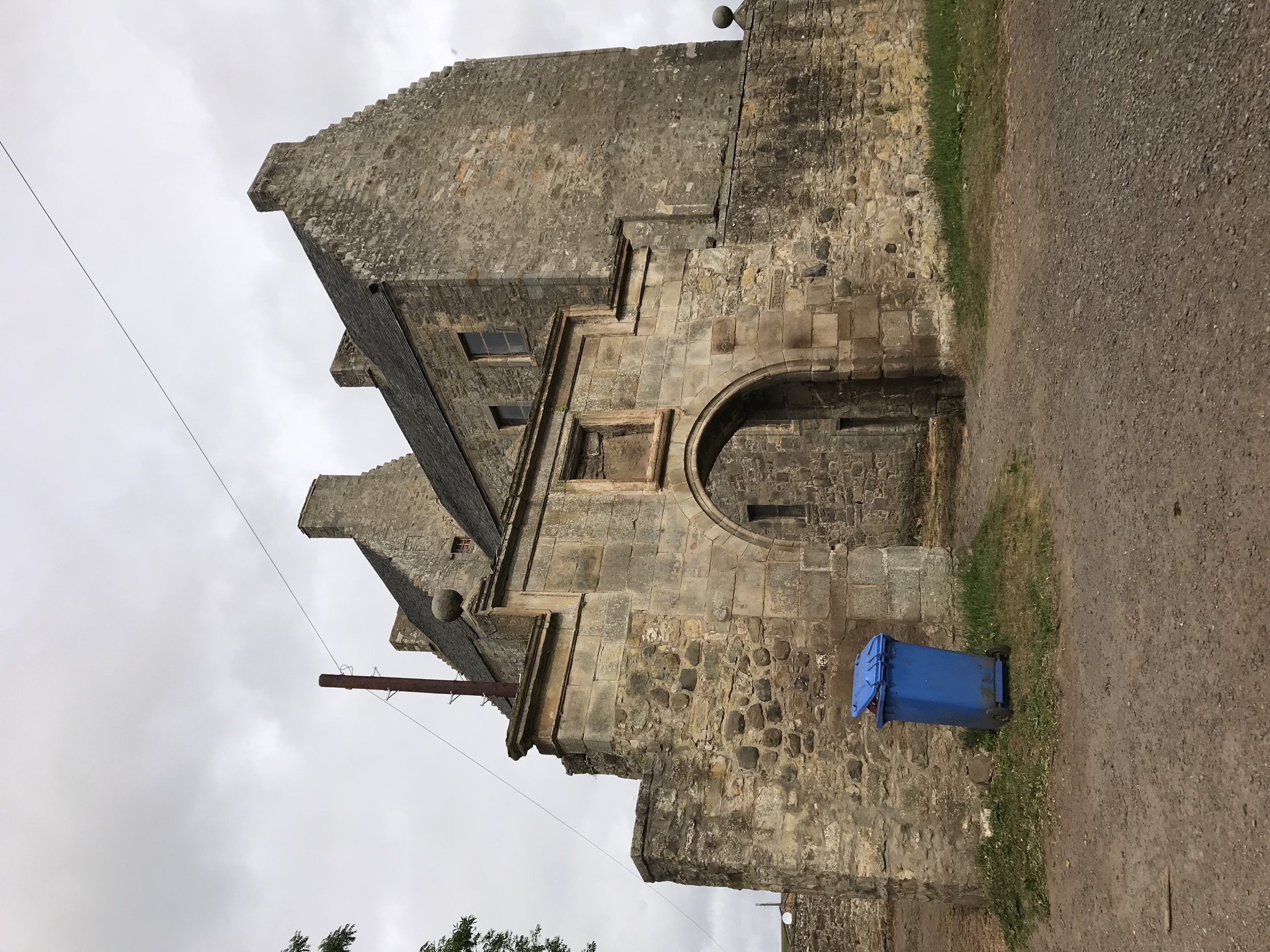 The arched stone gateway leading into the courtyard at Midhope Castle