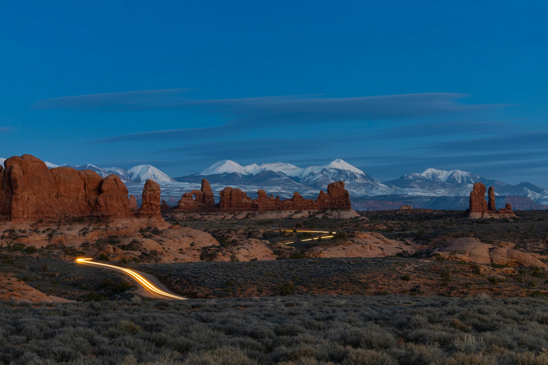A road leading through the red-rock landscape of Arches National Park
