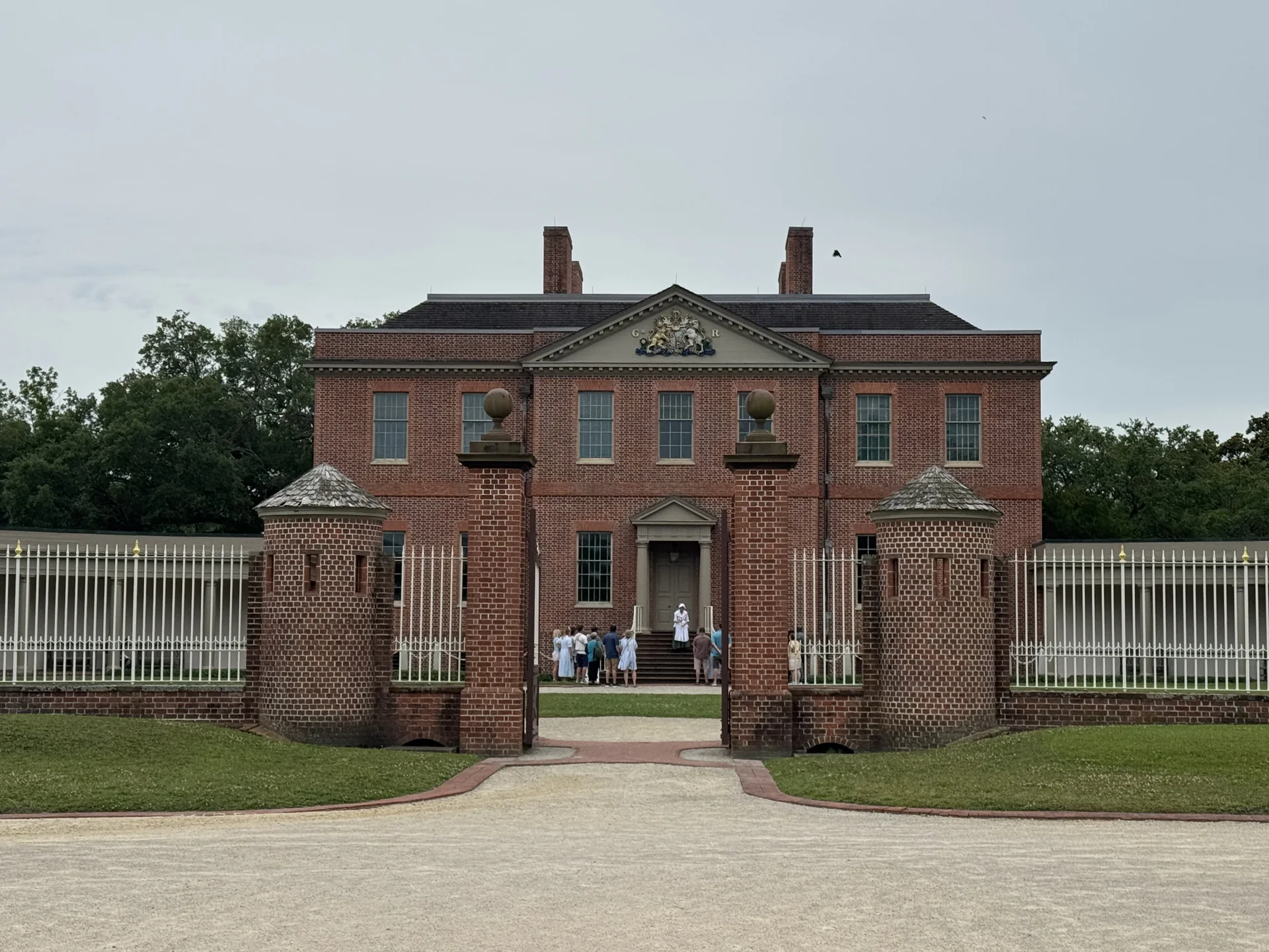 The red-brick front of Tryon Palace behind its gates in New Bern, photographed on our 2025 visit
