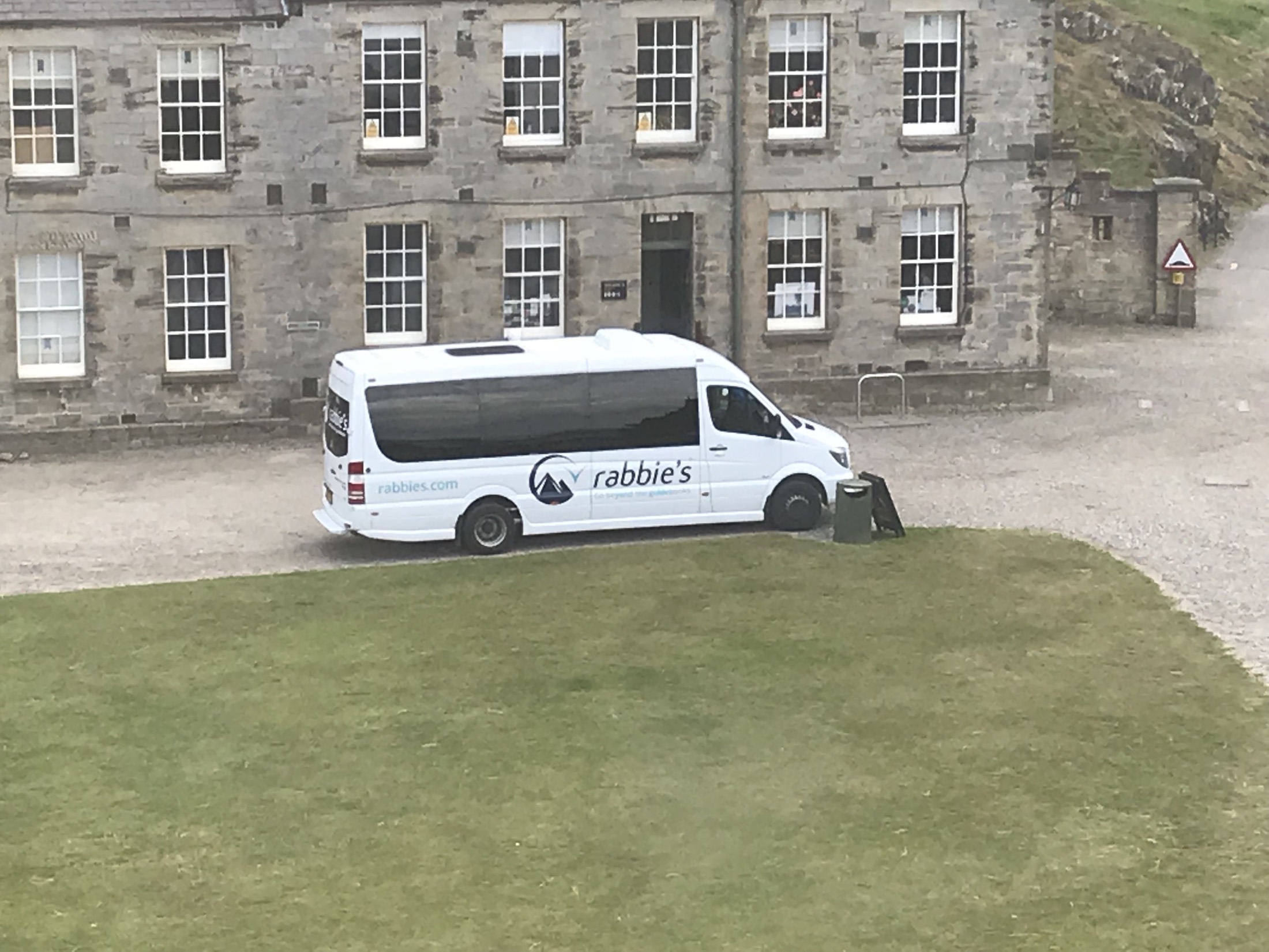 Our Rabbie’s mini coach parked beside Blackness Castle in Scotland