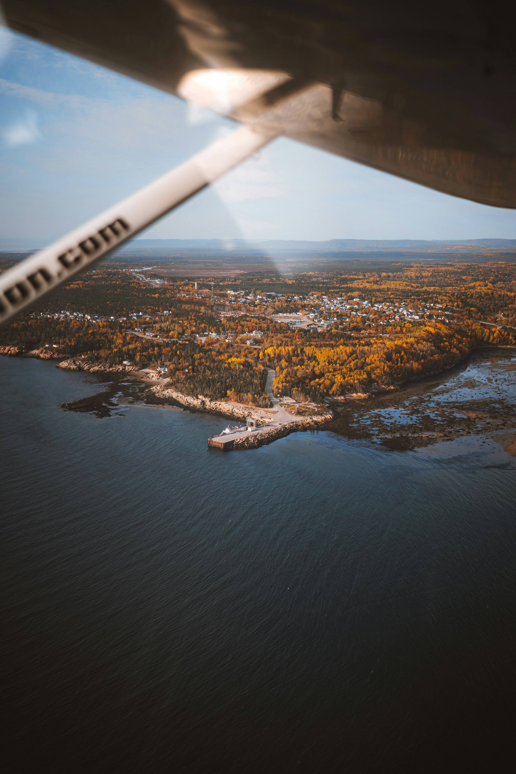 A quiet coastal town surrounded by autumn foliage