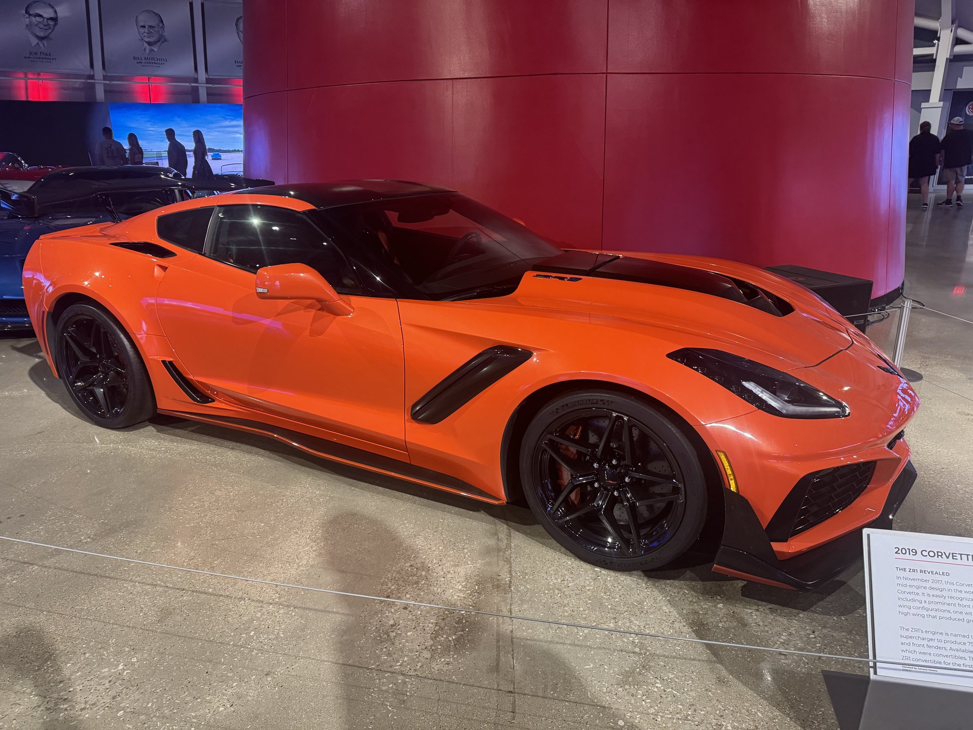 An orange Corvette on display at the National Corvette Museum
