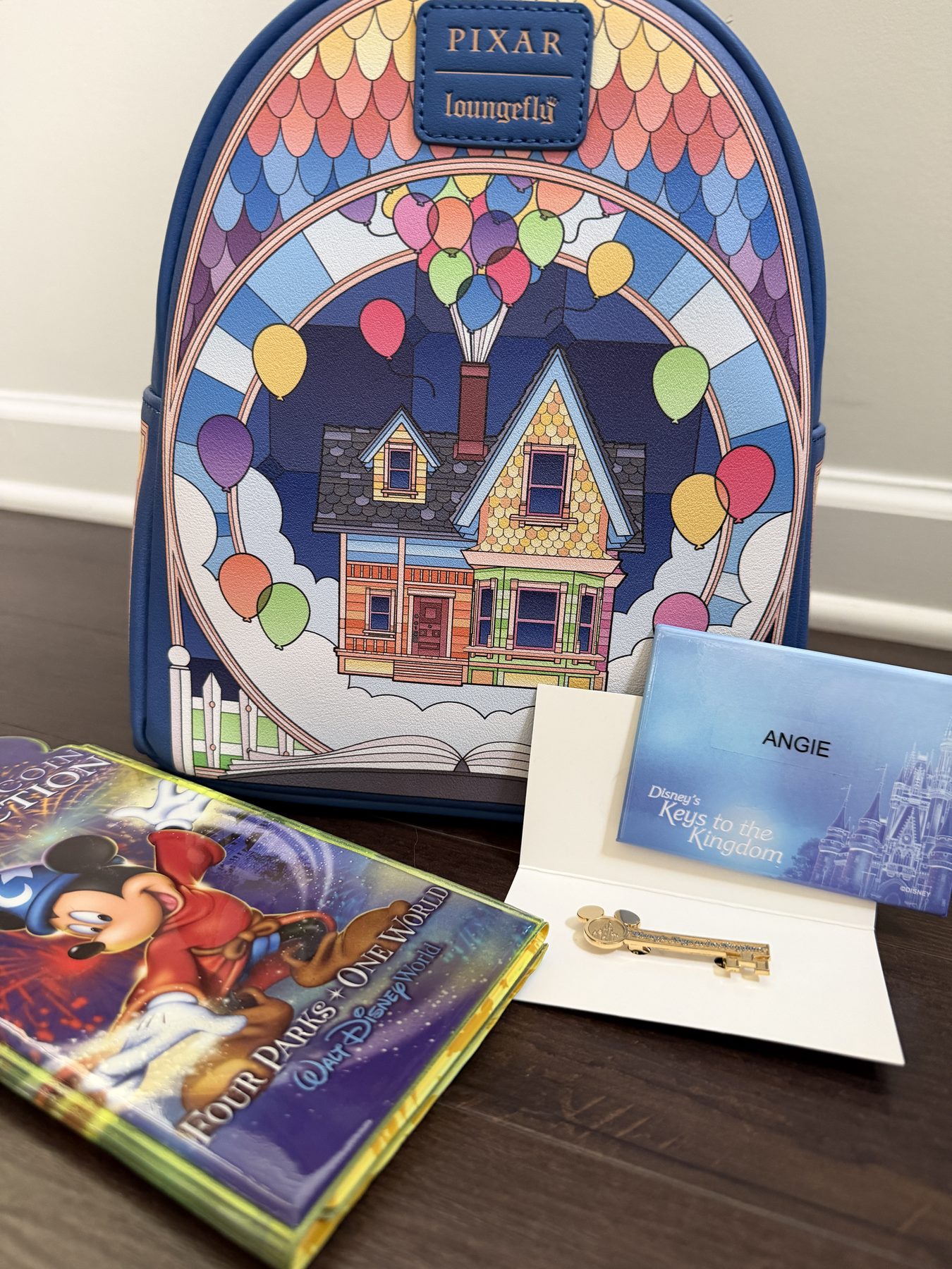 Souvenirs from Disney’s Keys to the Kingdom Tour, including a personalized name badge and commemorative key