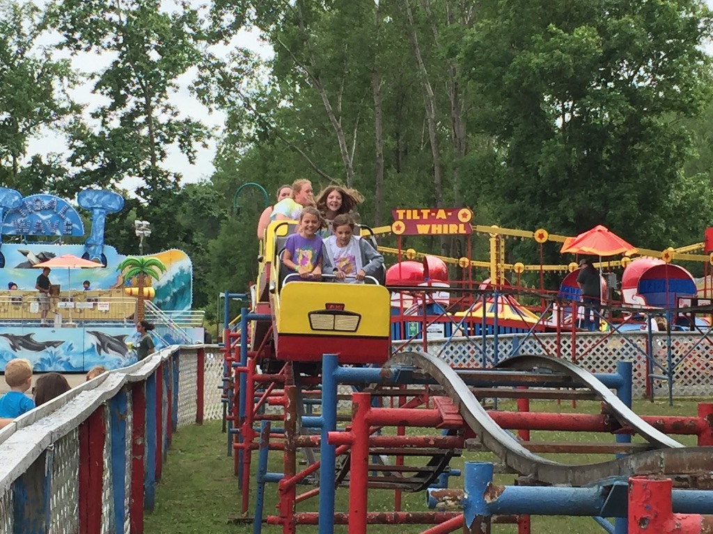Angie’s daughters riding the small roller coaster at Midway State Park in Bemus Point, New York